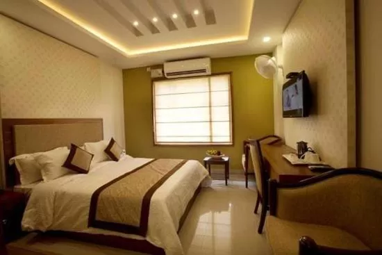 Bed in Glitz Inn Calicut