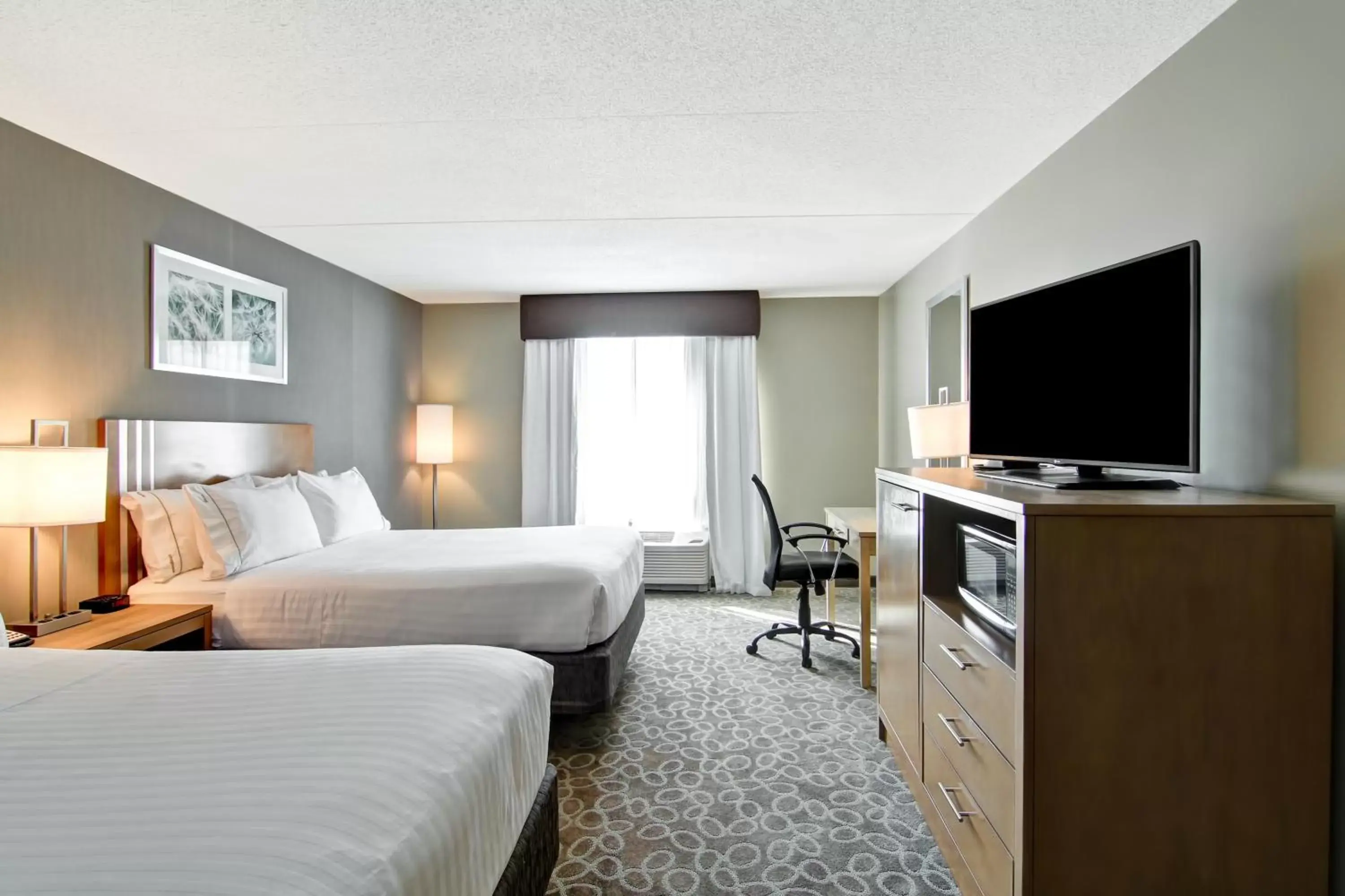 Photo of the whole room, TV/Entertainment Center in Holiday Inn Express & Suites Oshawa Downtown - Toronto Area, an IHG Hotel