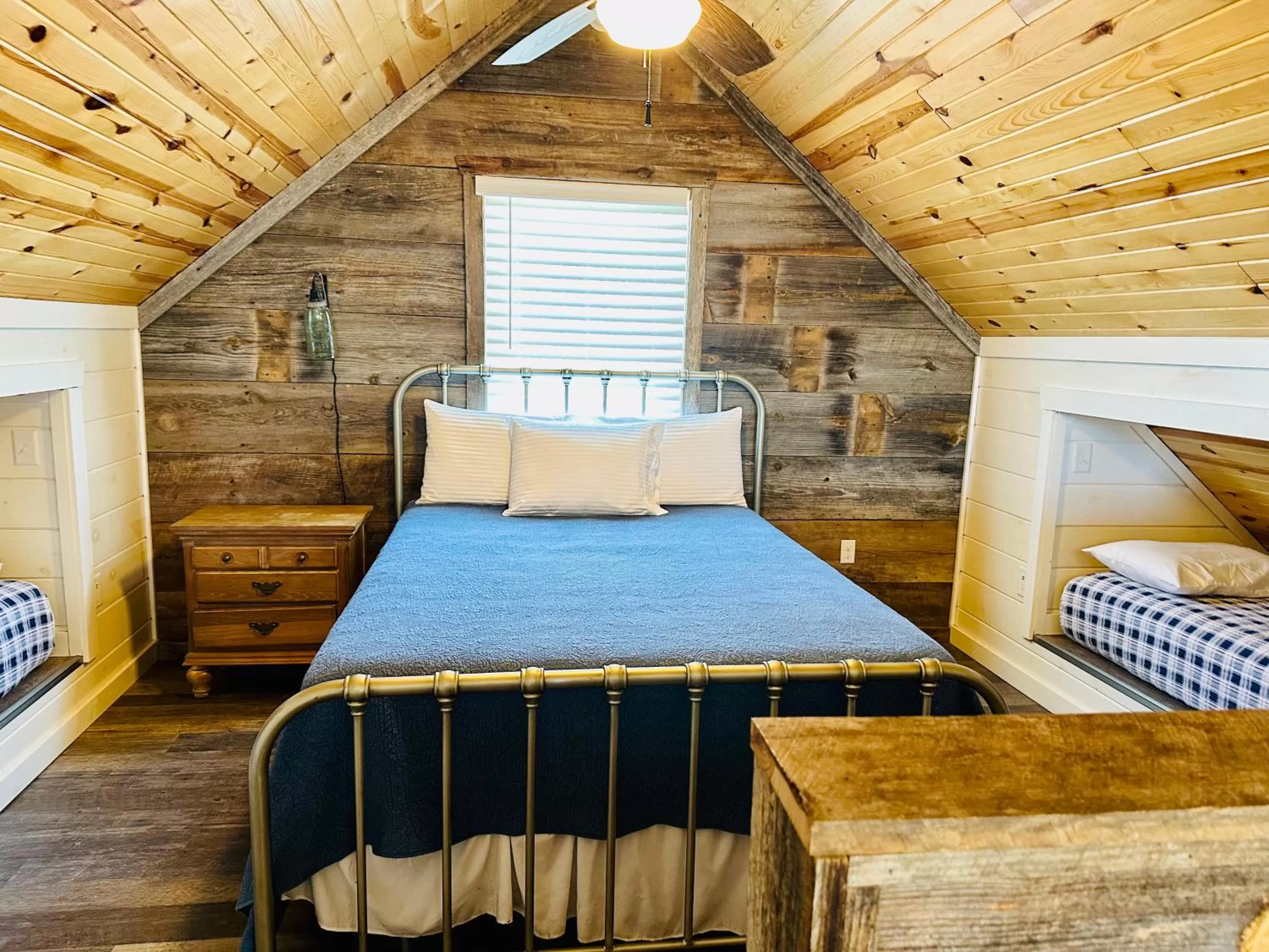 Bed in Knotty Squirrel Cabins