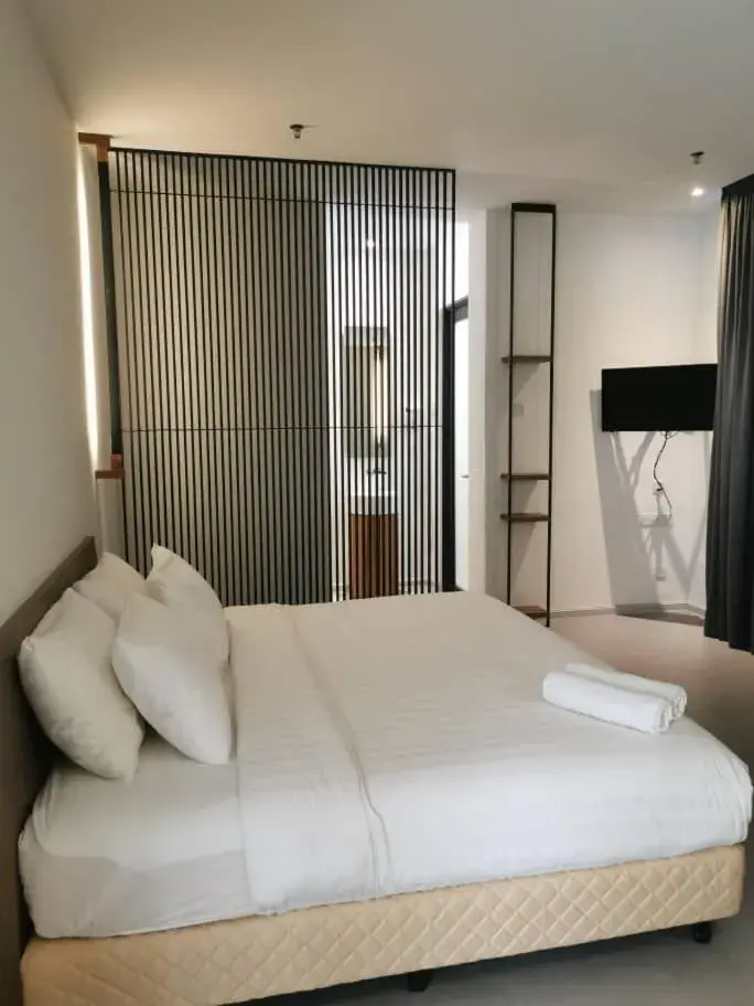 Bed in T+ PREMIUM HOTEL