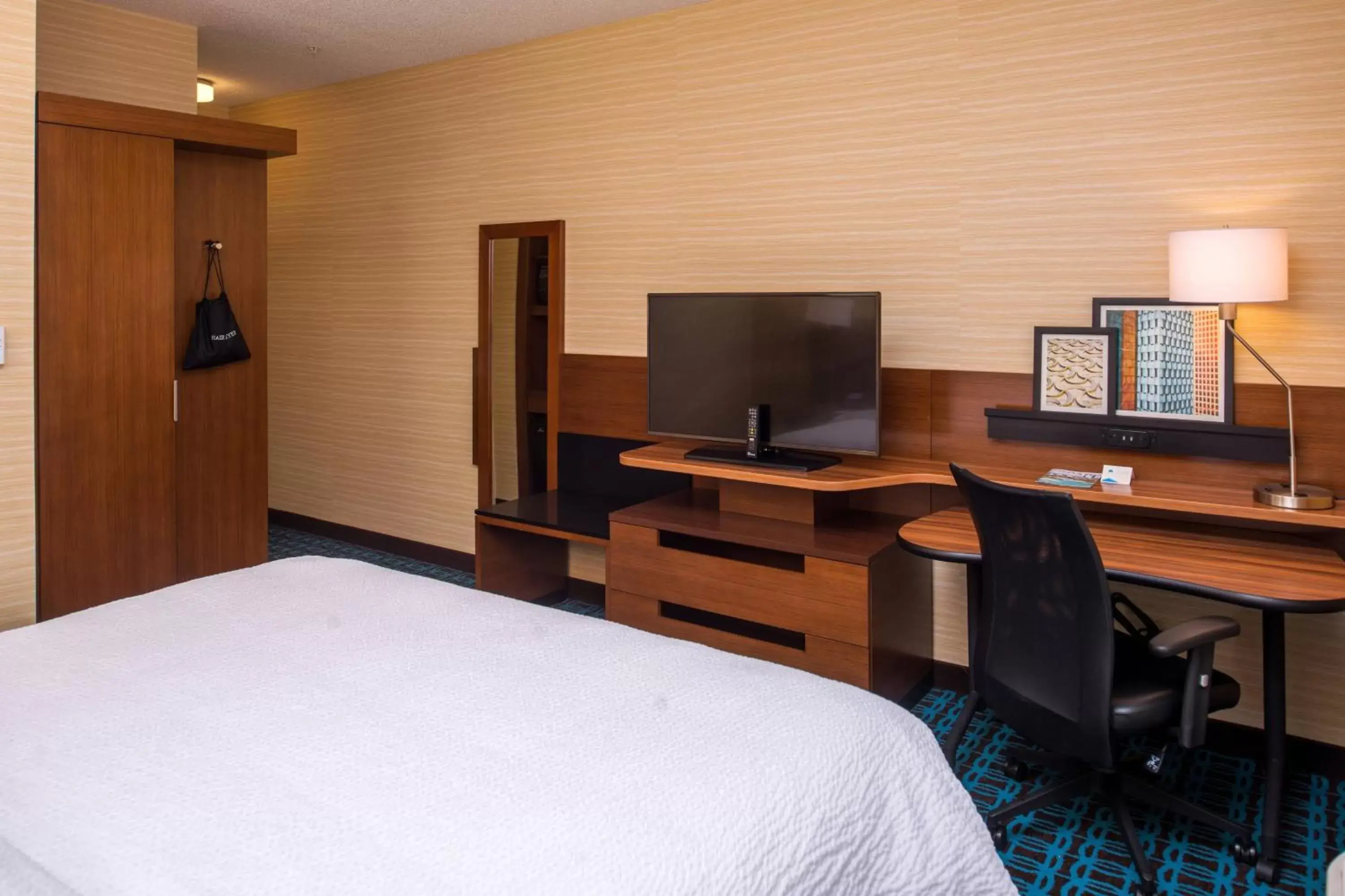 Photo of the whole room, TV/Entertainment Center in Fairfield Inn & Suites by Marriott St. Louis Westport