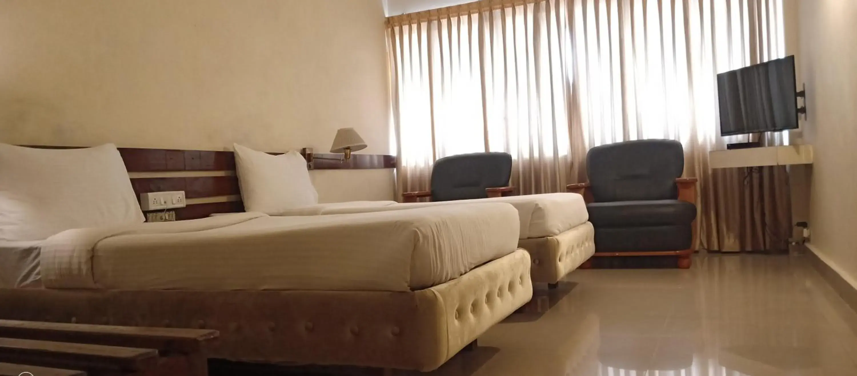 Bed in Hotel Poonja International