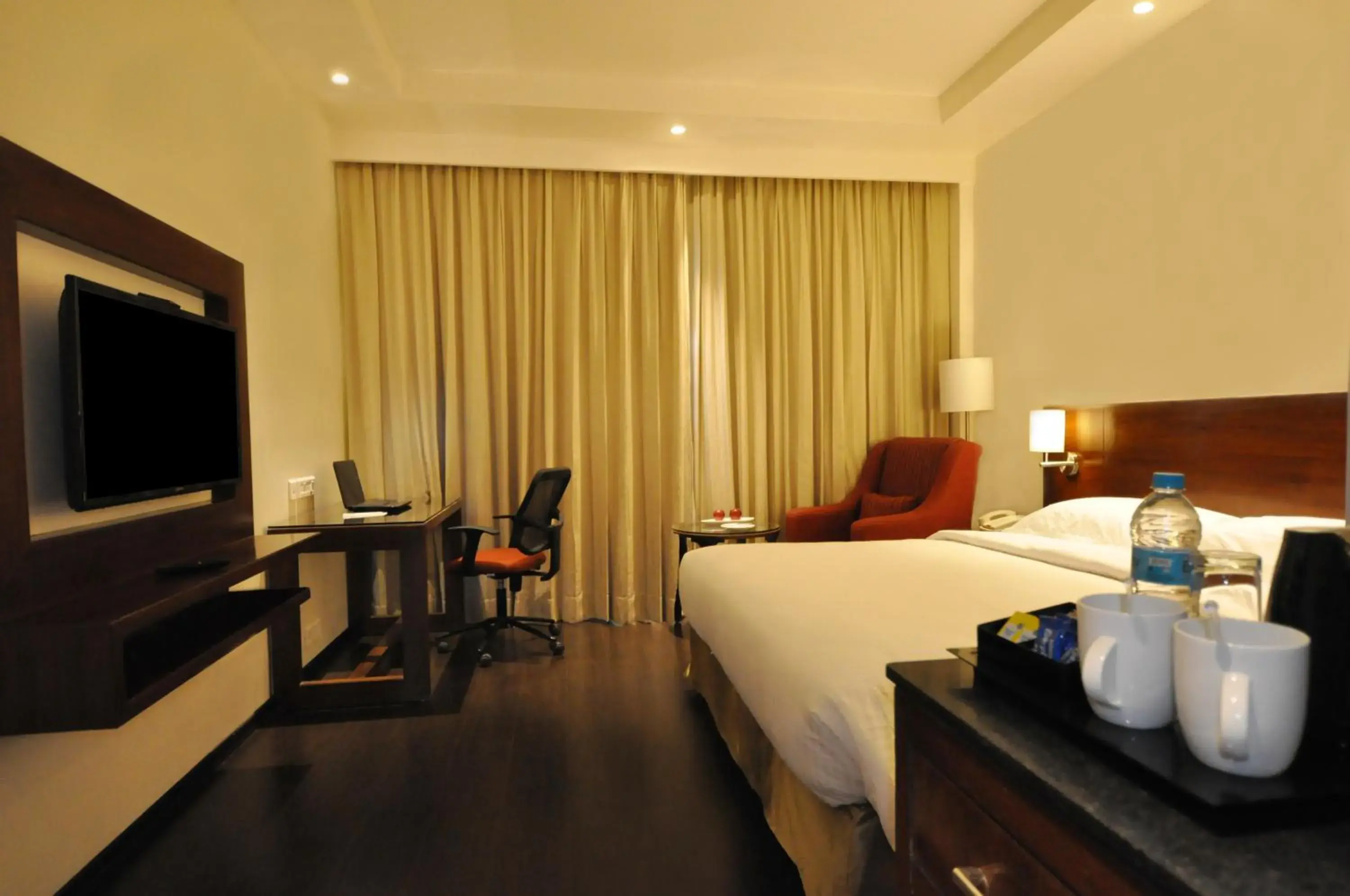 Bedroom, TV/Entertainment Center in Hotel Marigold- Sitapura