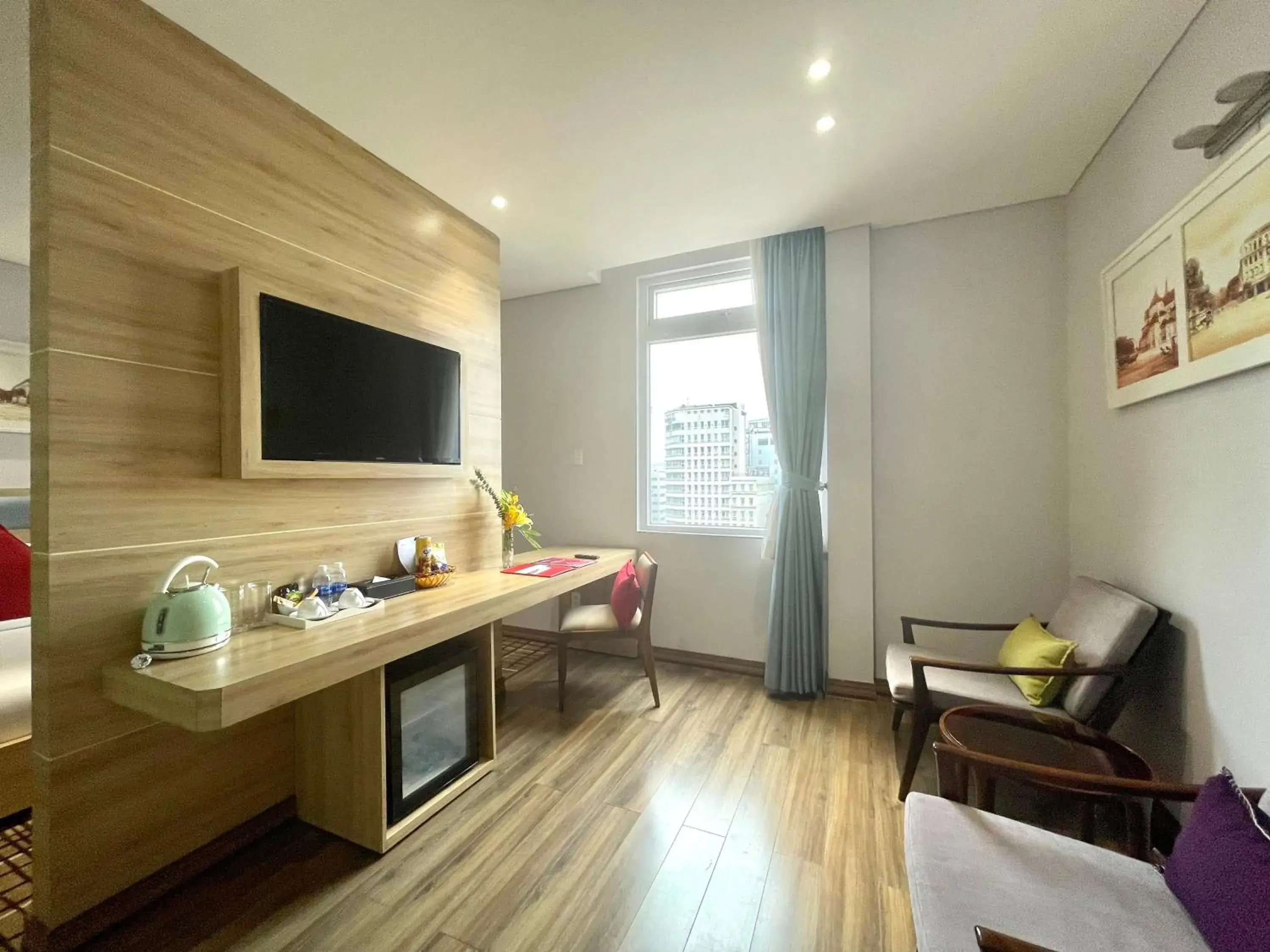Photo of the whole room, TV/Entertainment Center in RAMADA ENCORE BY WYNDHAM SAIGON D1 - Formerly M Boutique Hotel Saigon