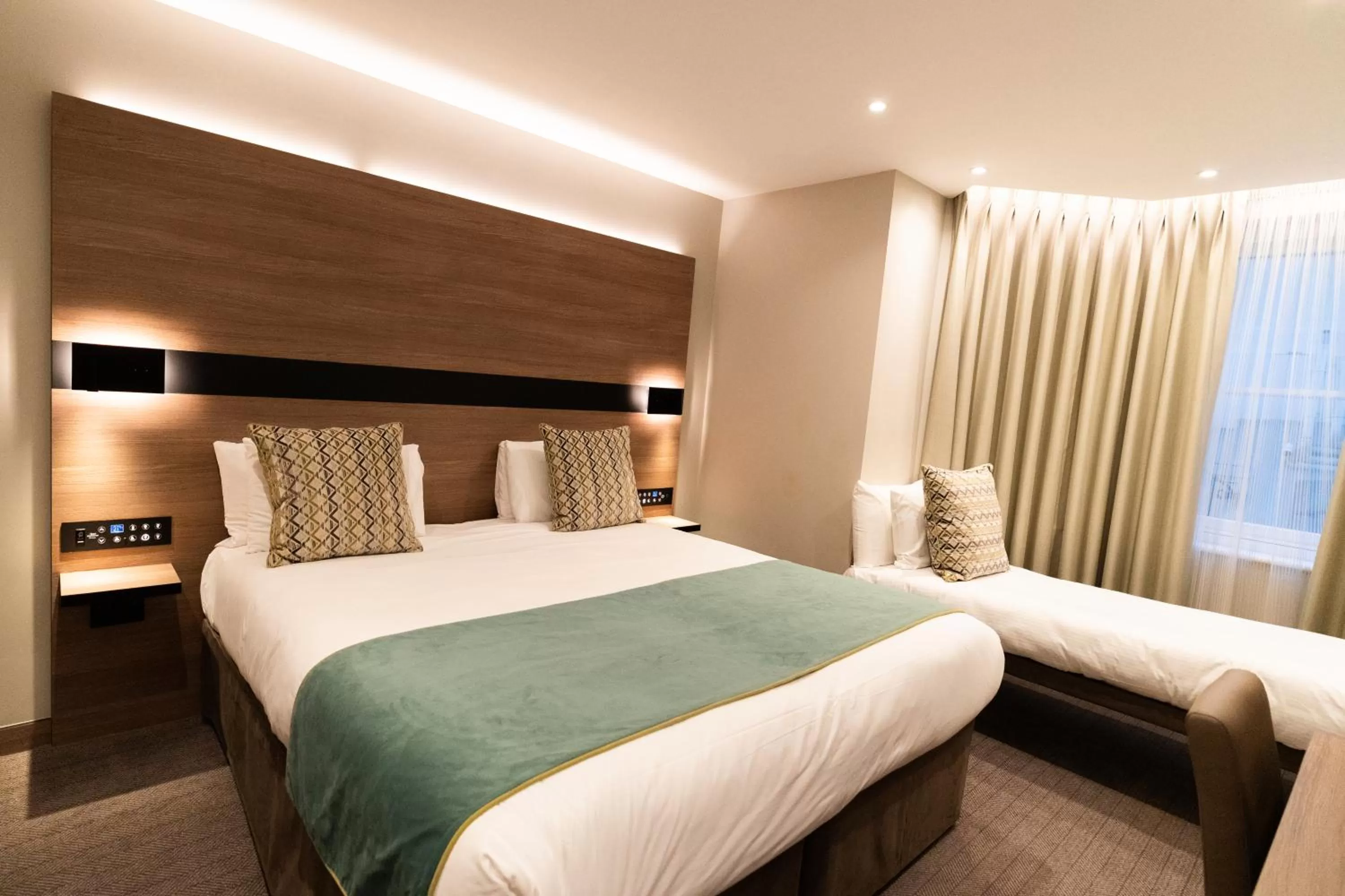 Bed in Merit Kensington Hotel