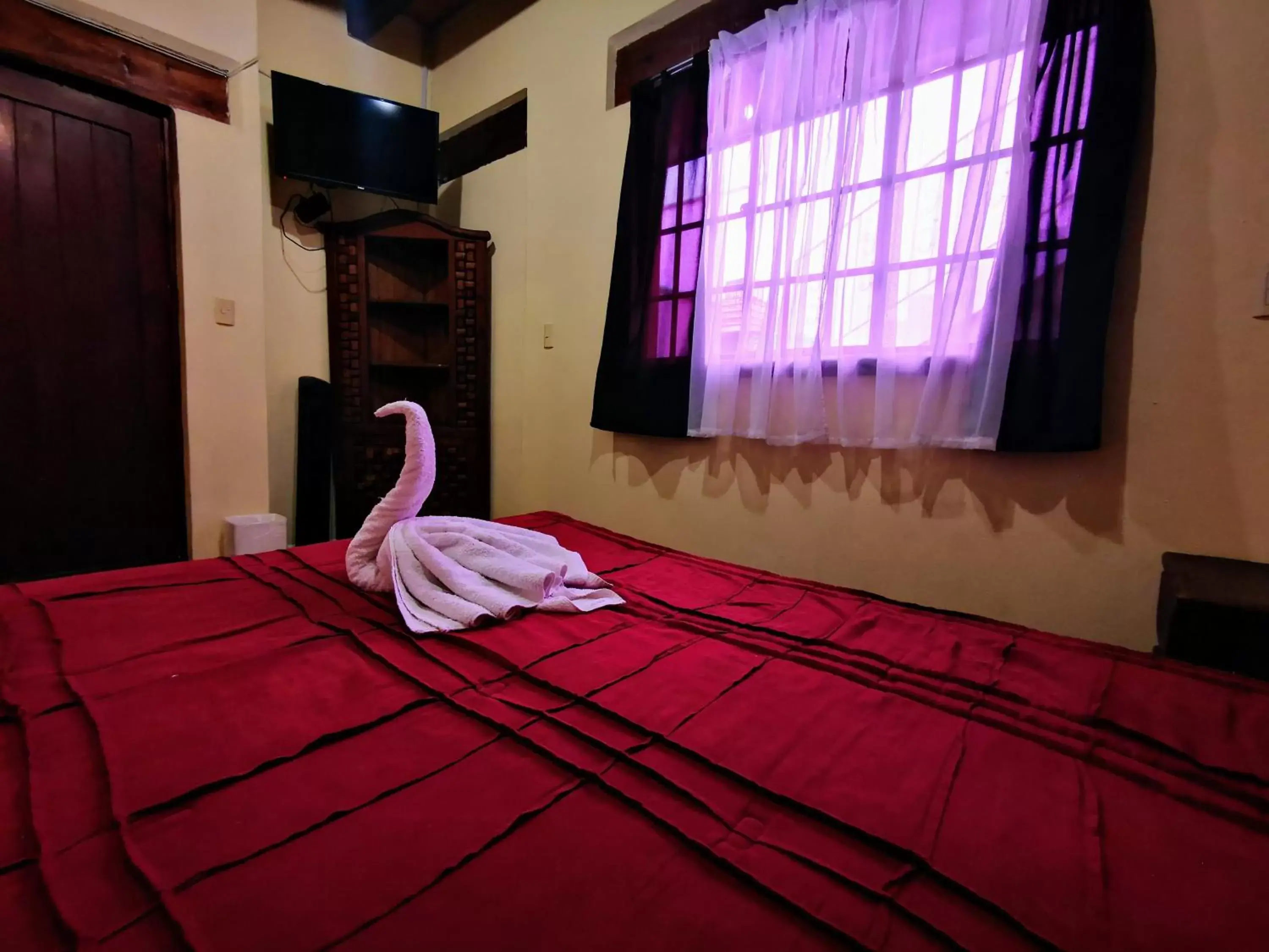 Bed, TV/Entertainment Center in Hotel Chocolate Suites