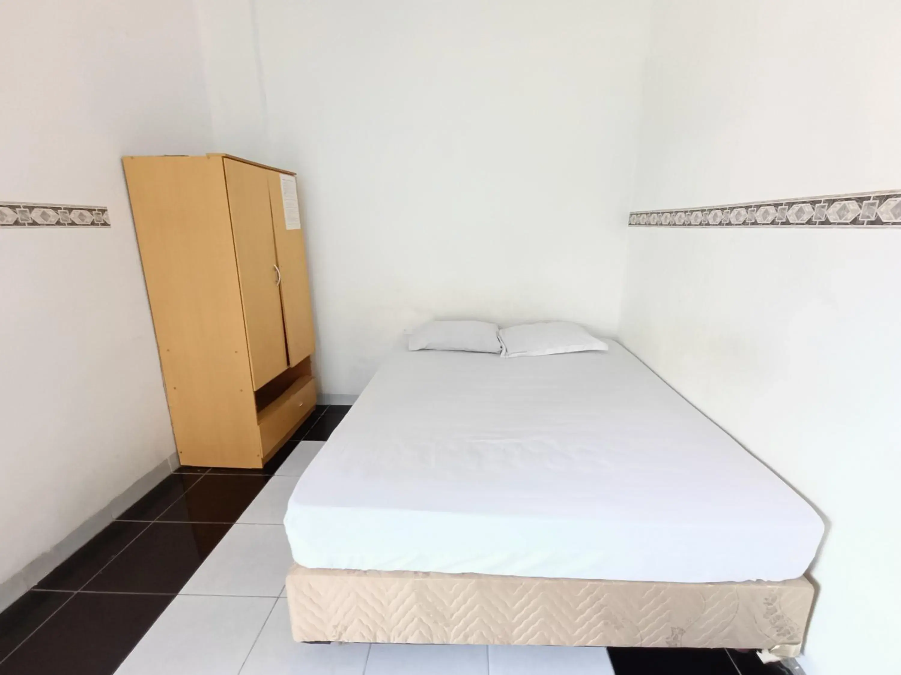 Bed in OYO 90260 Bumi Merpati Residence