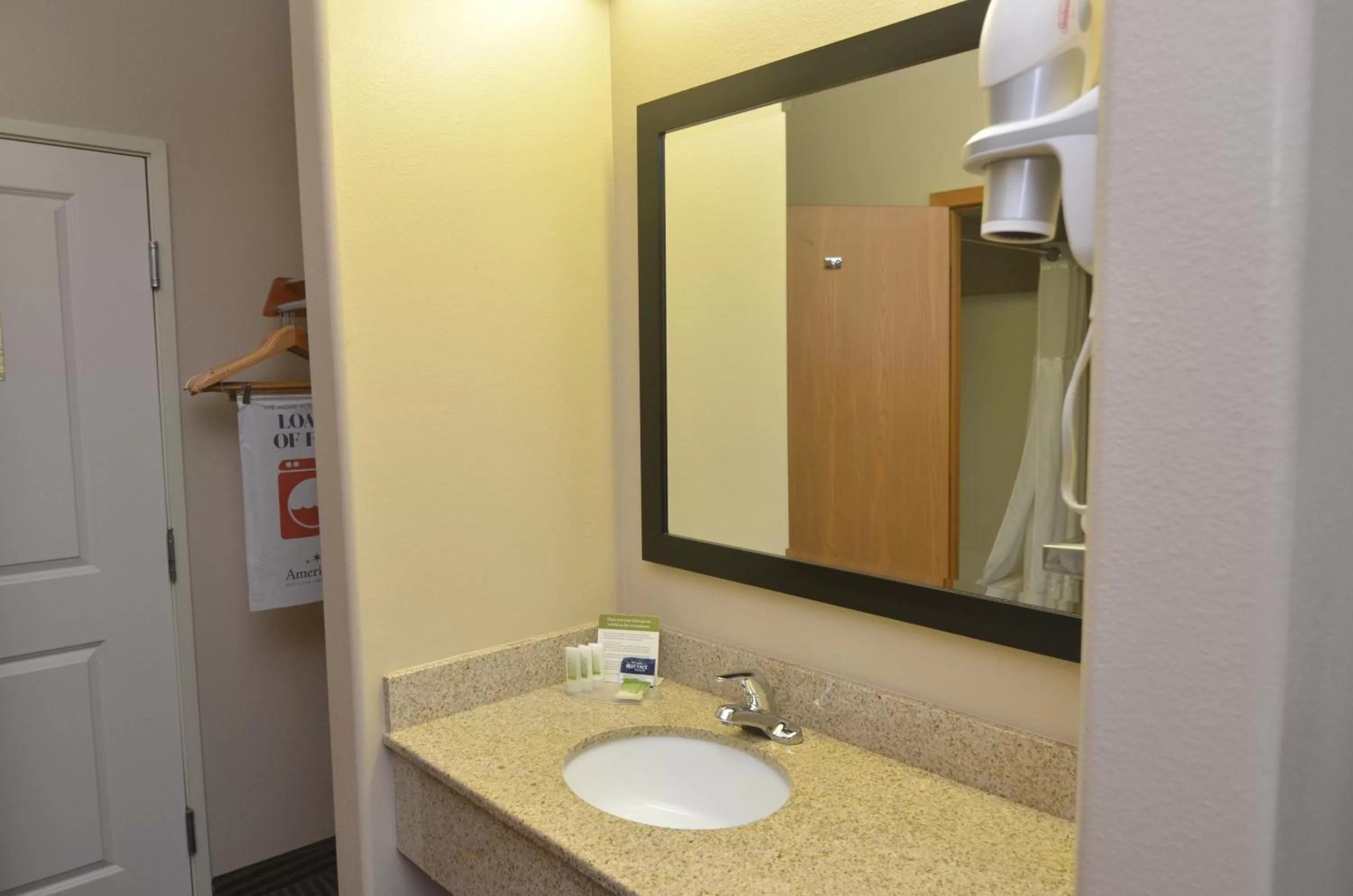 Bathroom in AmericInn by Wyndham Des Moines Airport