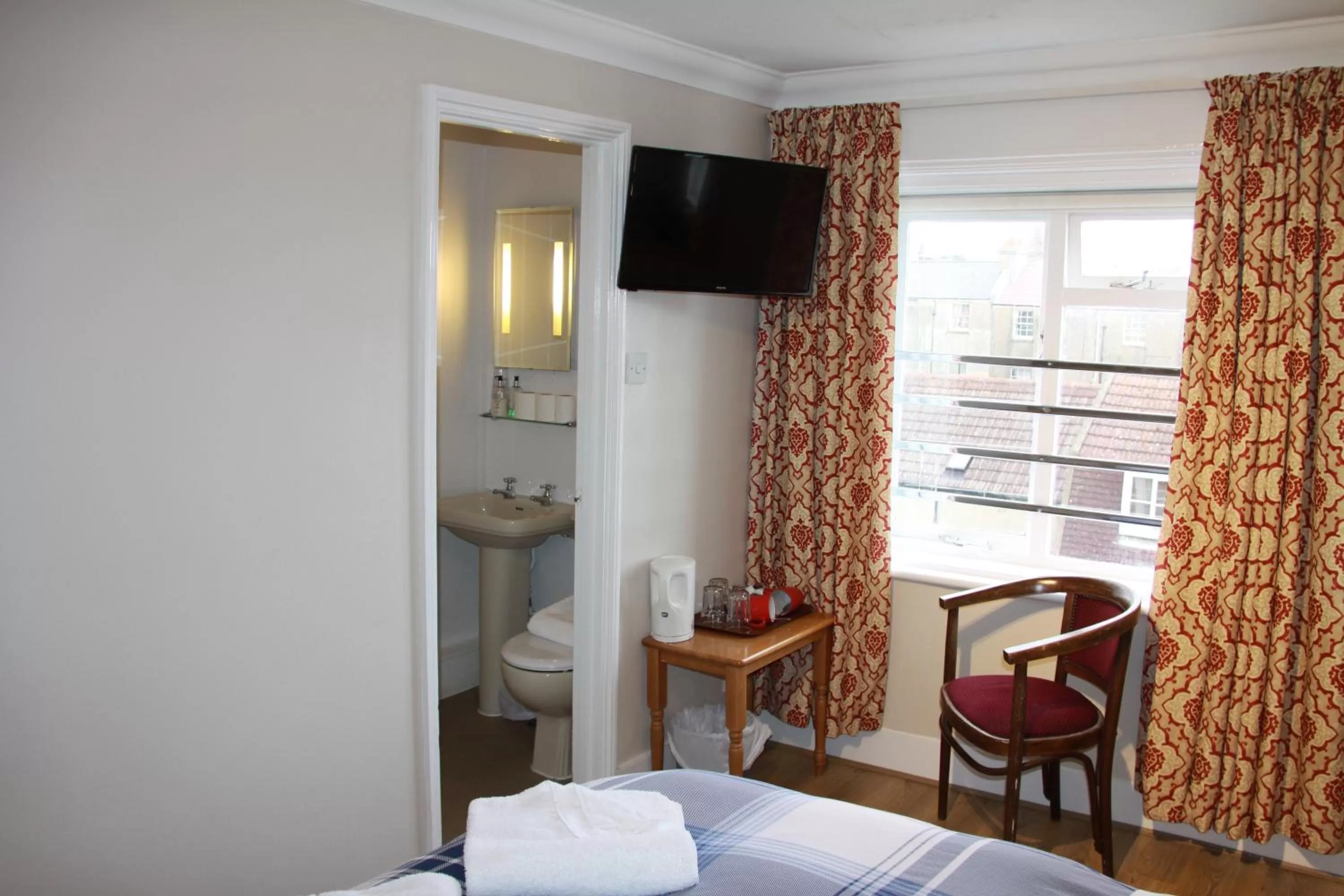 Bed in Ambassador Hotel