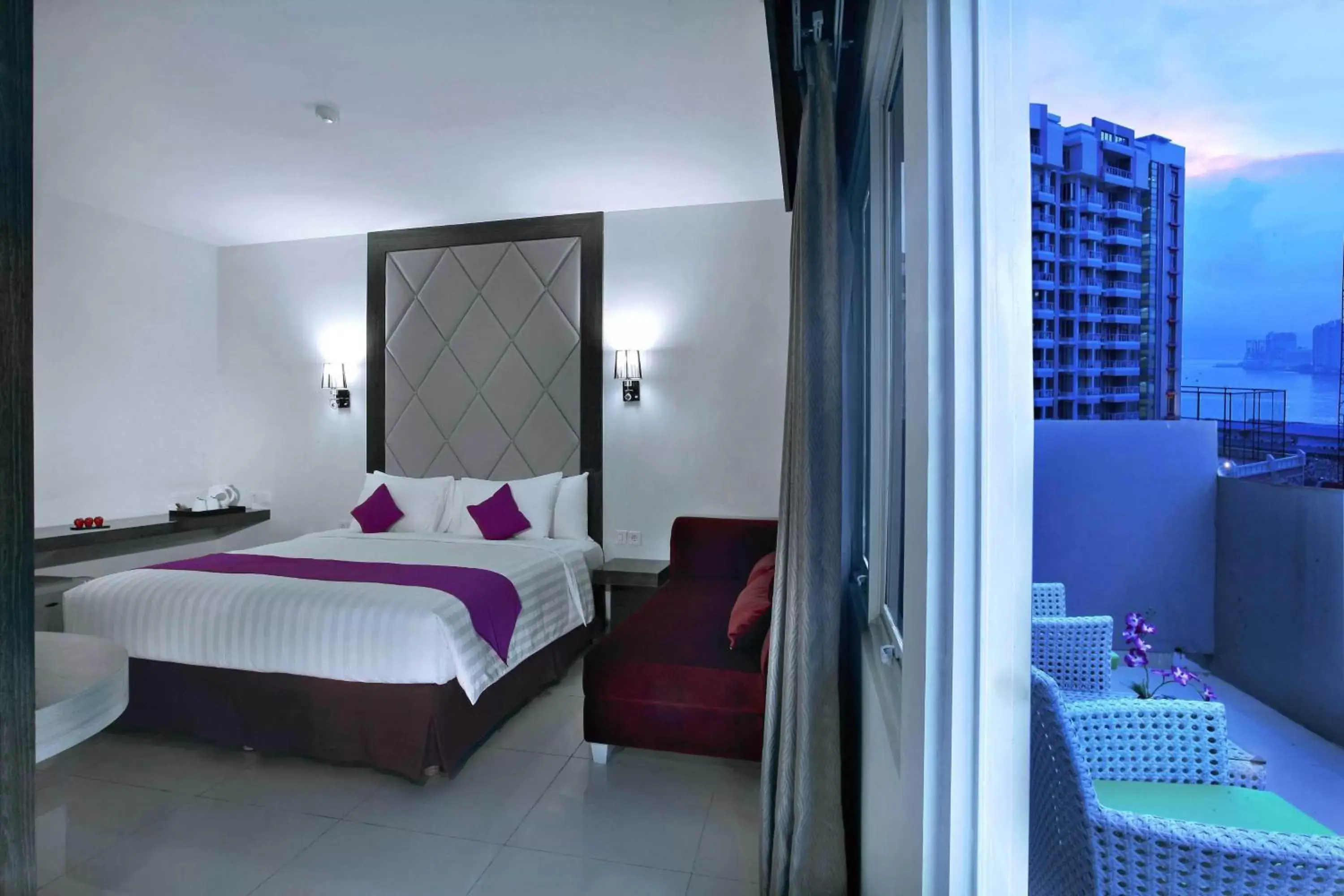 Balcony/Terrace, Bed in Quest Hotel Balikpapan by ASTON