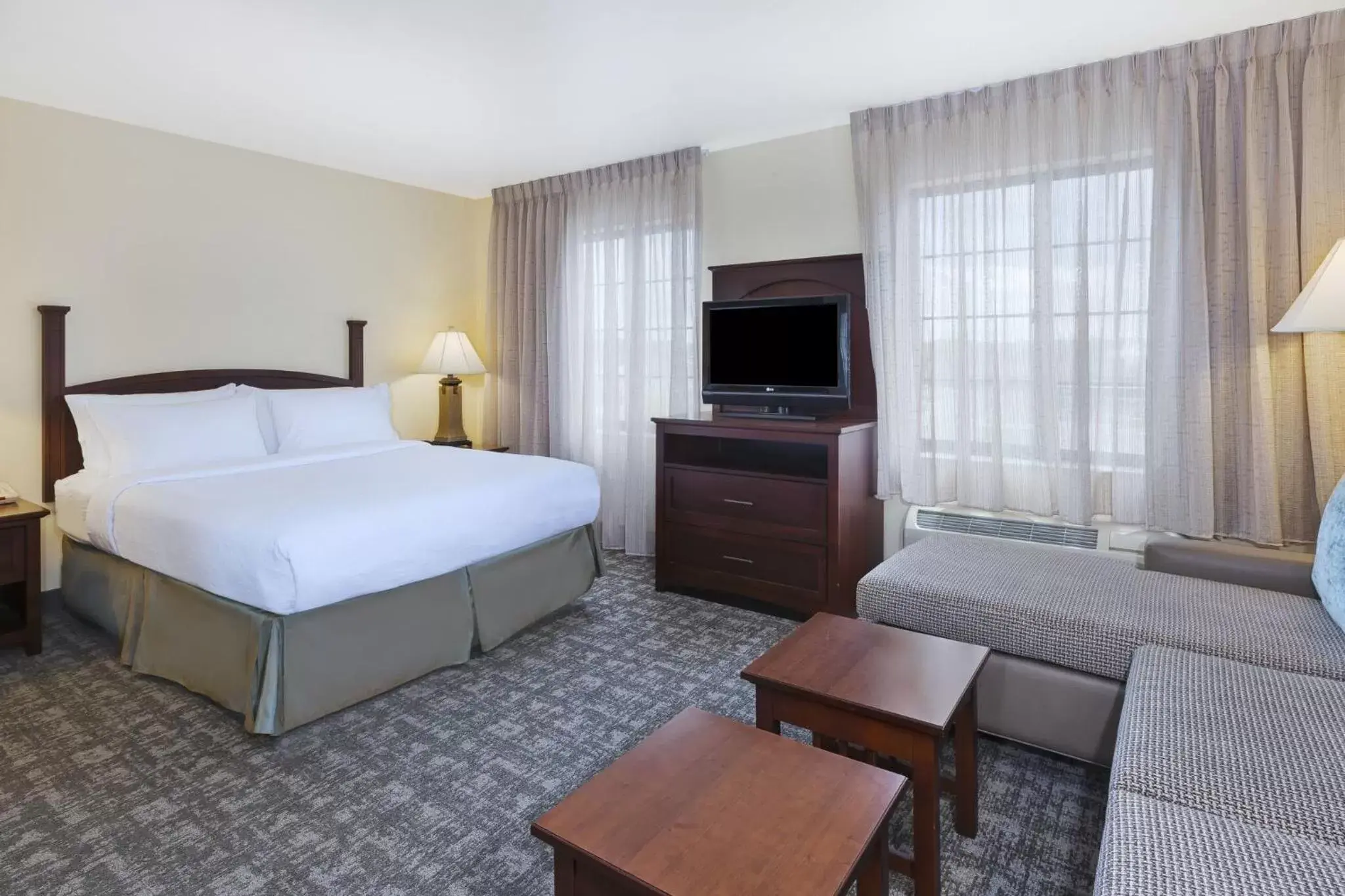 Bed in Staybridge Suites Lansing-Okemos, an IHG Hotel