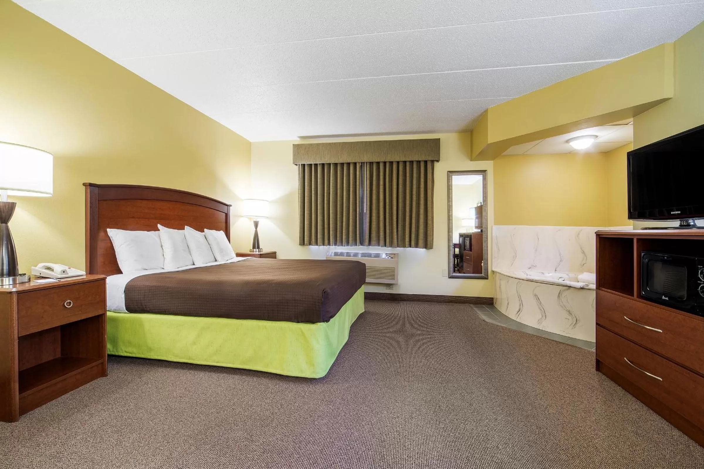 Bed in AmericInn by Wyndham Sioux Falls