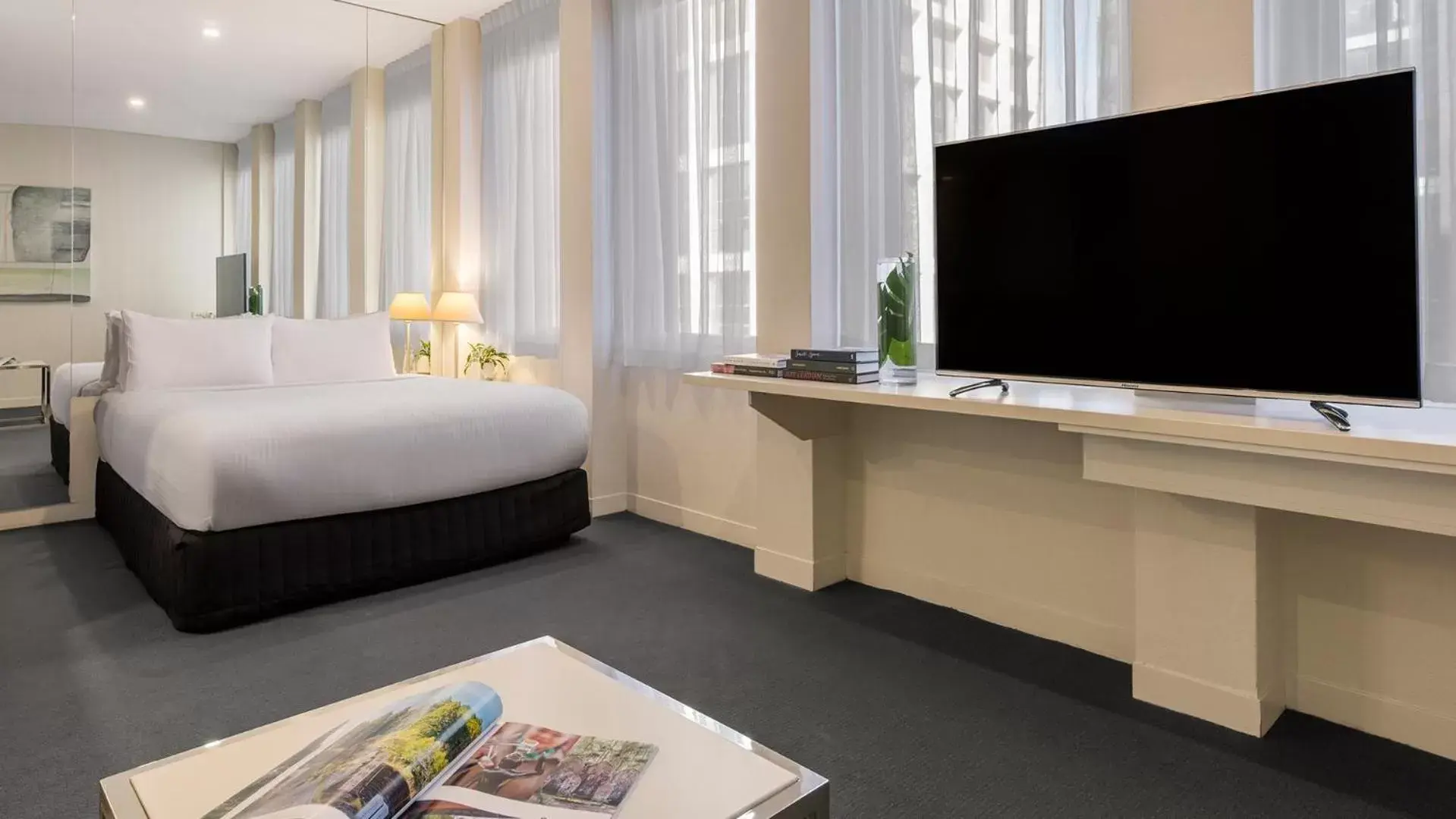 Bed, TV/Entertainment Center in Oaks Melbourne on Collins Hotel