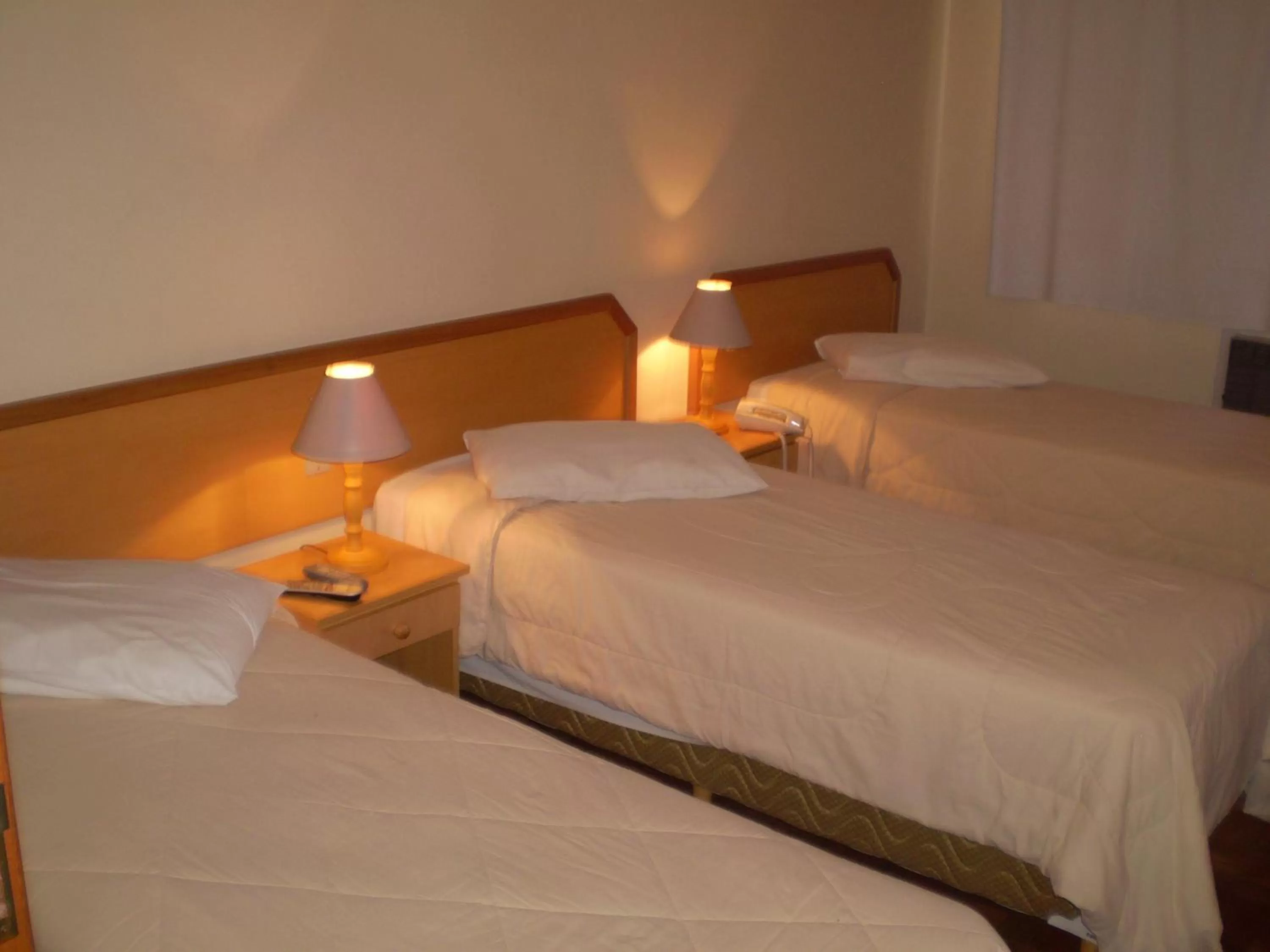 Bed in Hotel Gravataí Center