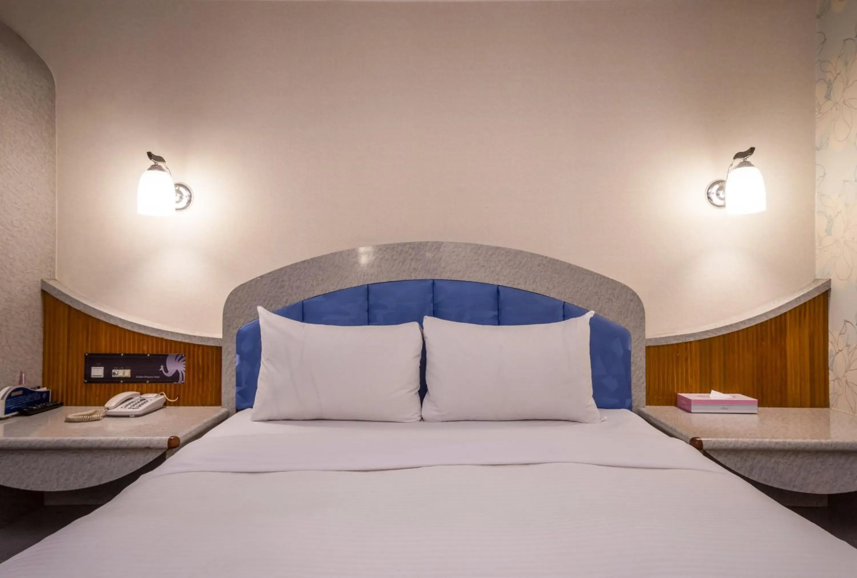 Bed in Golden Phoenix Hotel