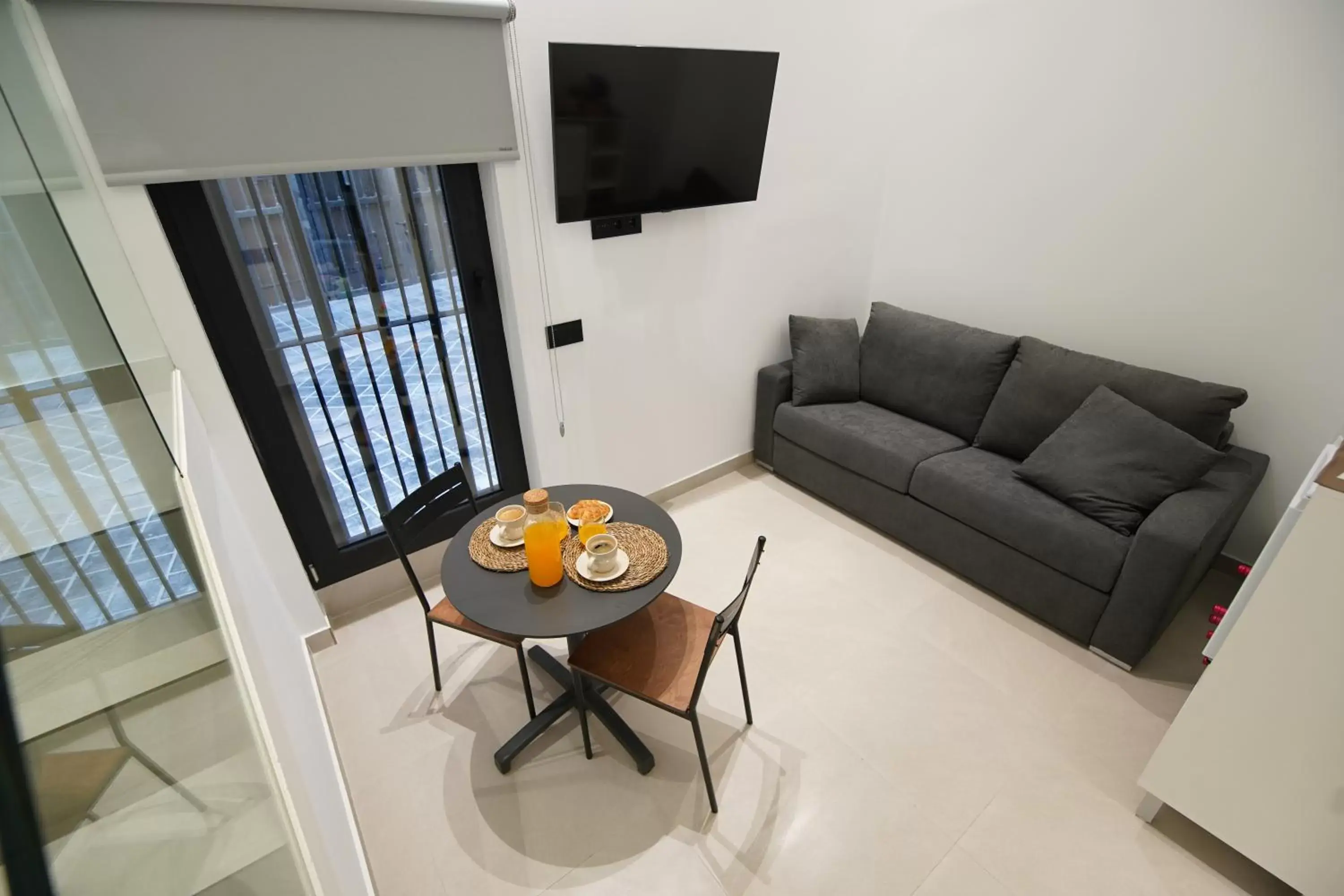 TV and multimedia, Seating Area in Suites Puerto Valencia
