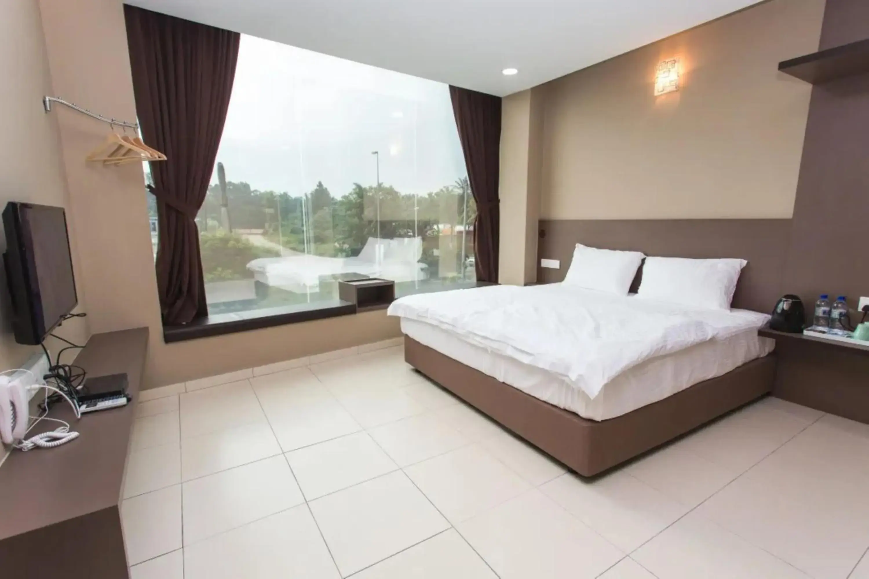 Bedroom in Tropika Garden Hotel