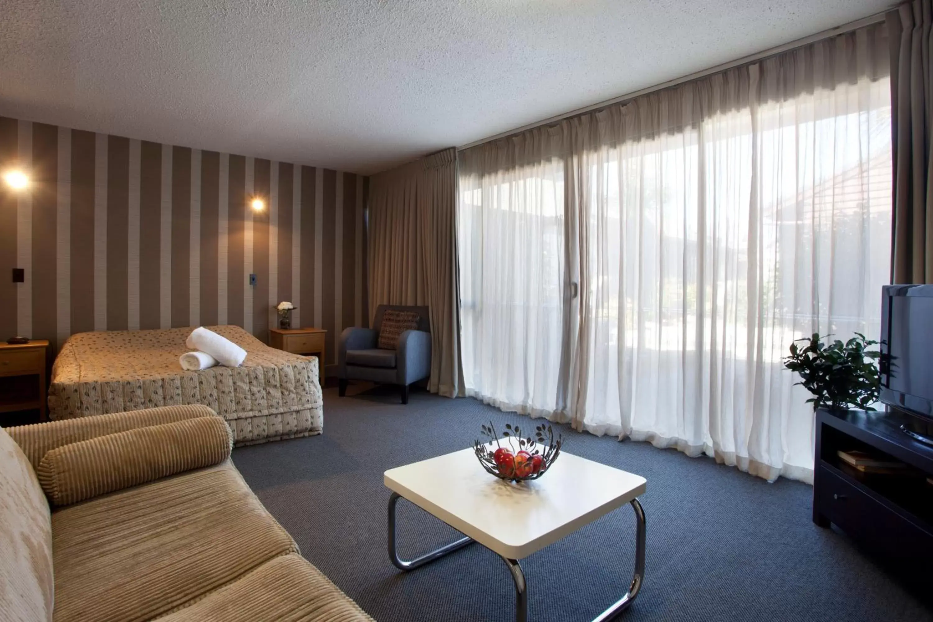 Bedroom, Seating Area in The Lofts Apartments