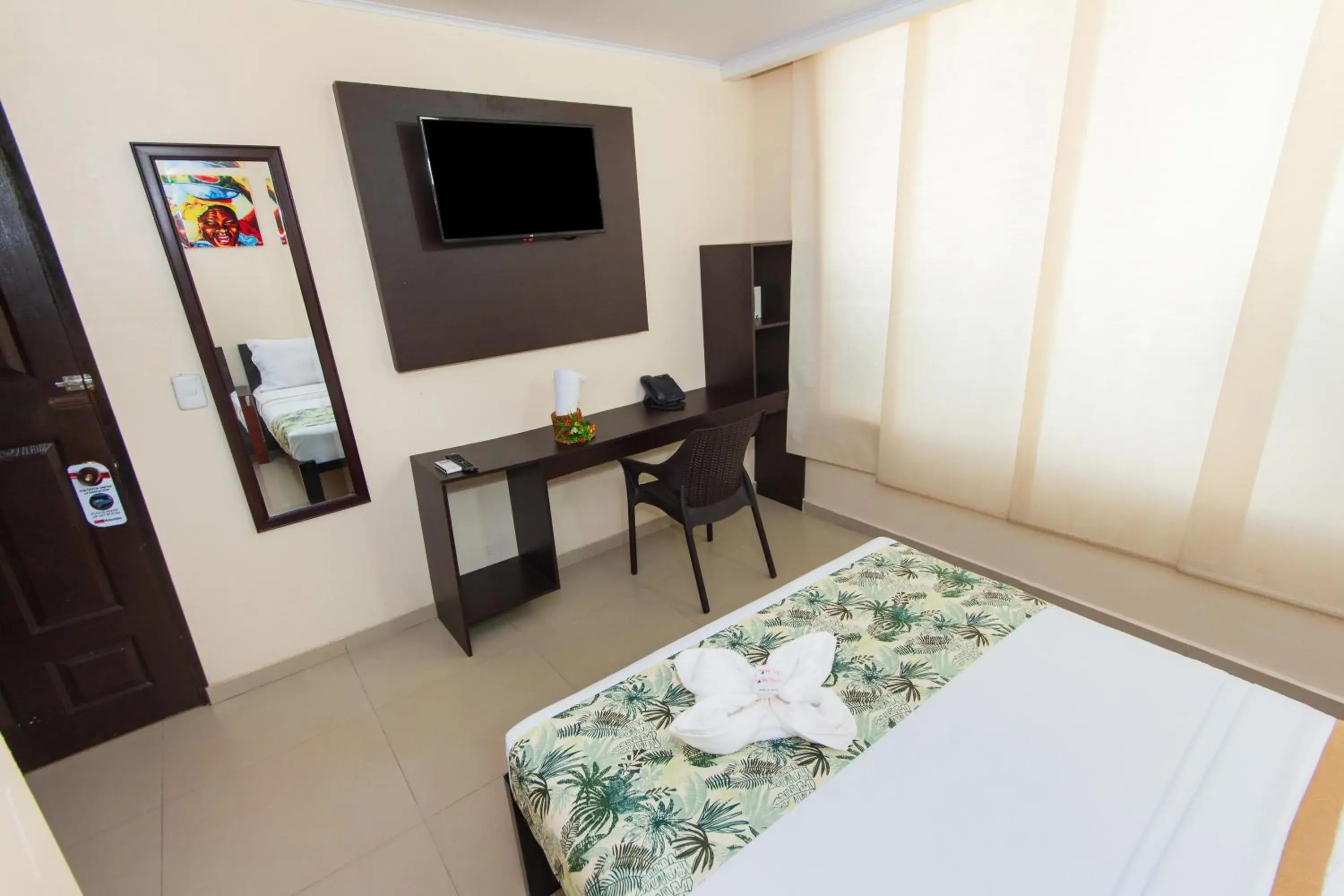 Bed, TV/Entertainment Center in Hotel Marina Suites By GEH Suites