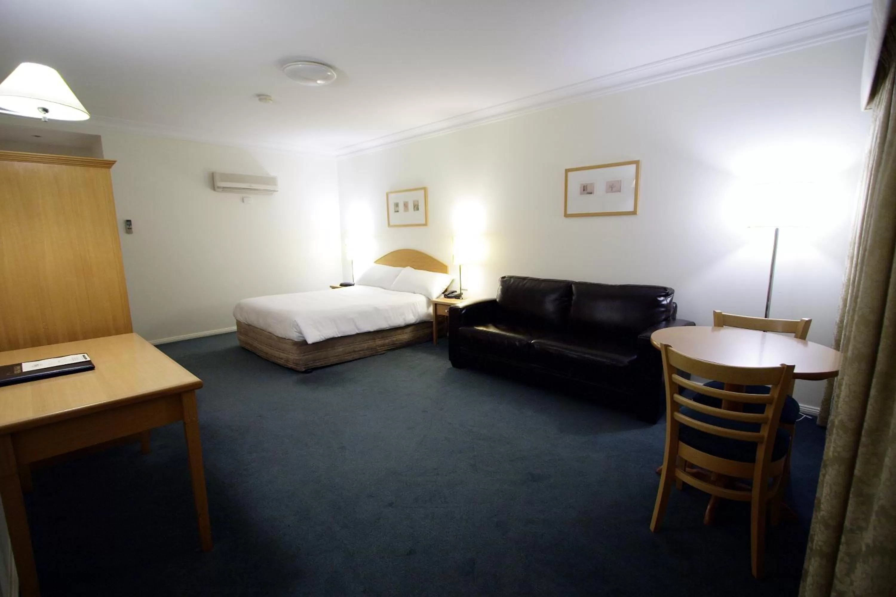 Bed in Carlyle Suites & Apartments