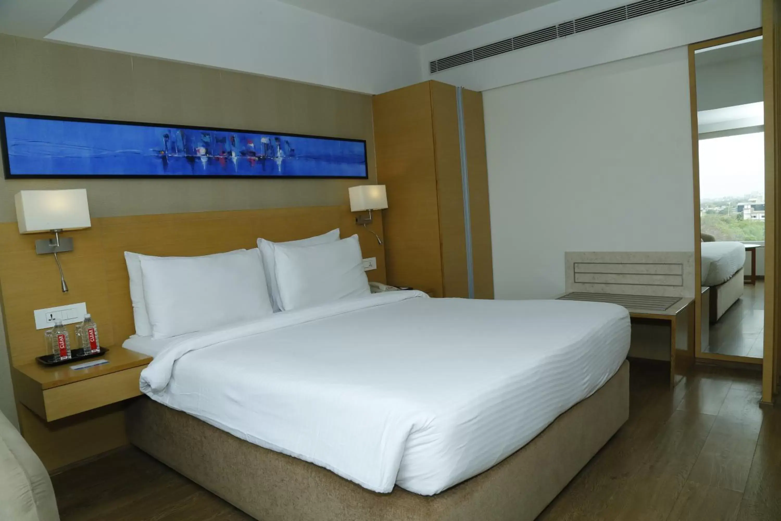 Bed in Sarovar Portico Rivera Ahmedabad