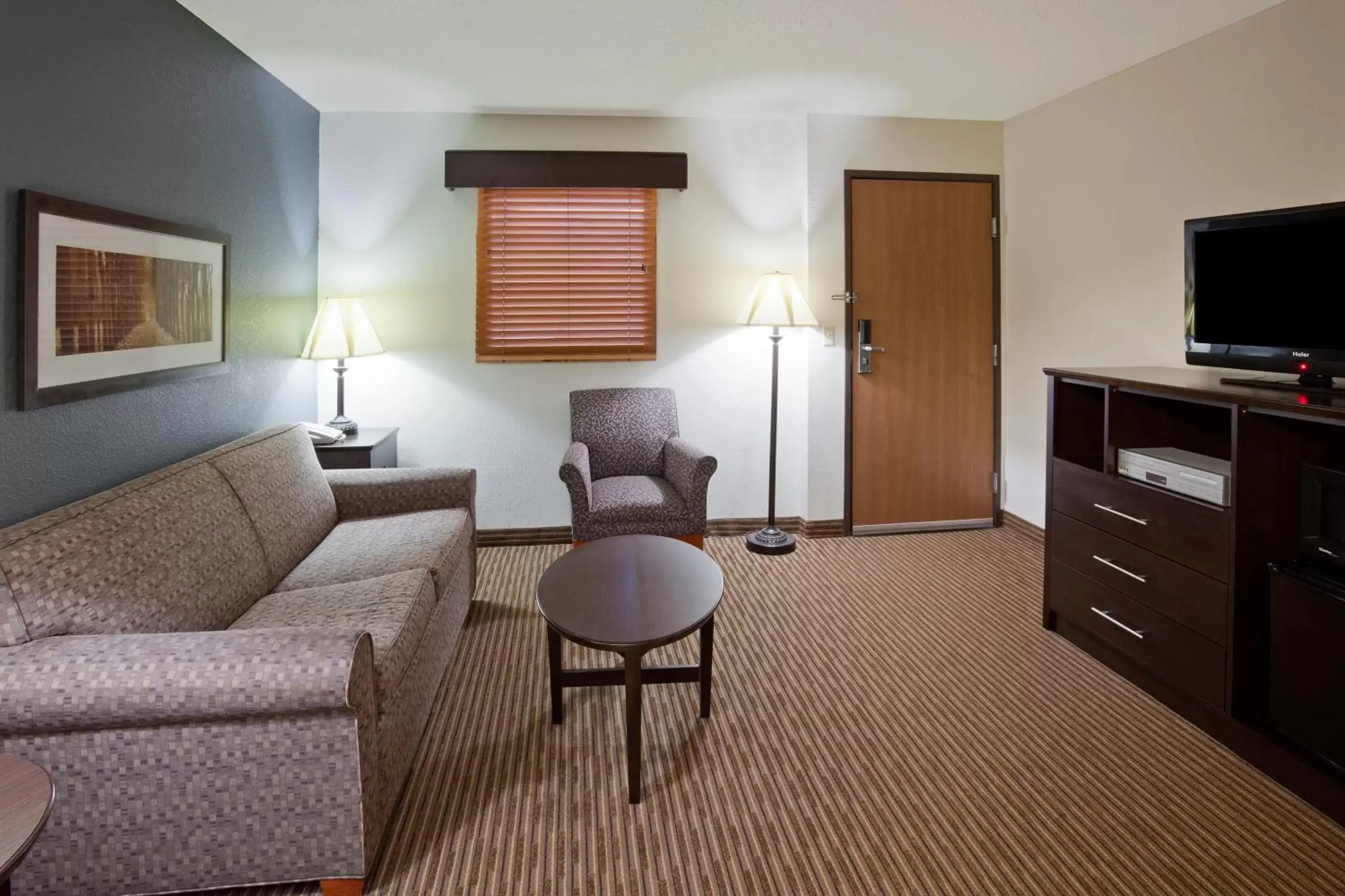 TV and multimedia, Seating Area in AmericInn by Wyndham Menominee