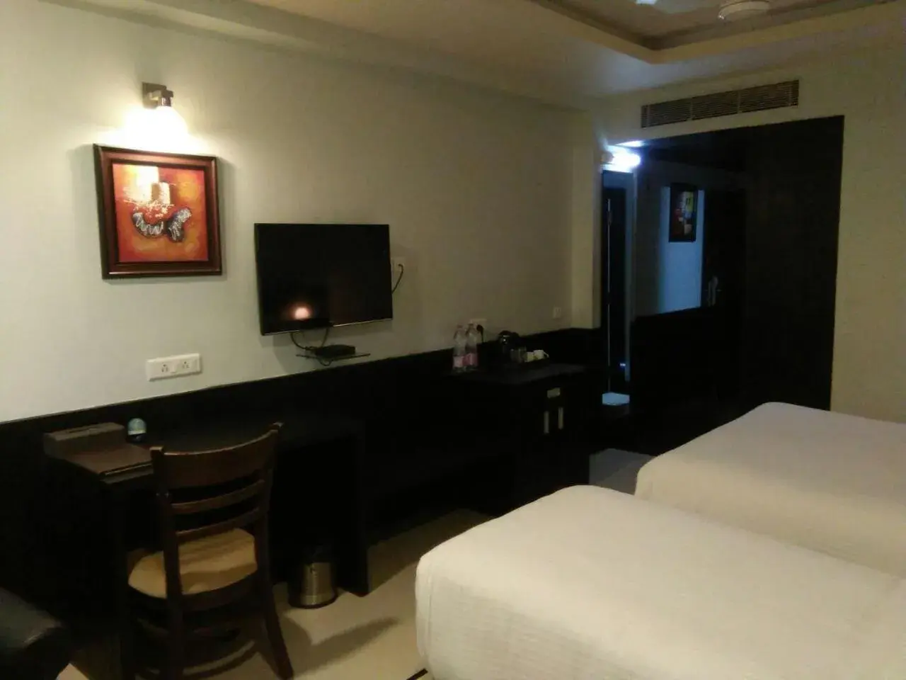 Bed, TV/Entertainment Center in Pride Ananya Resort Puri