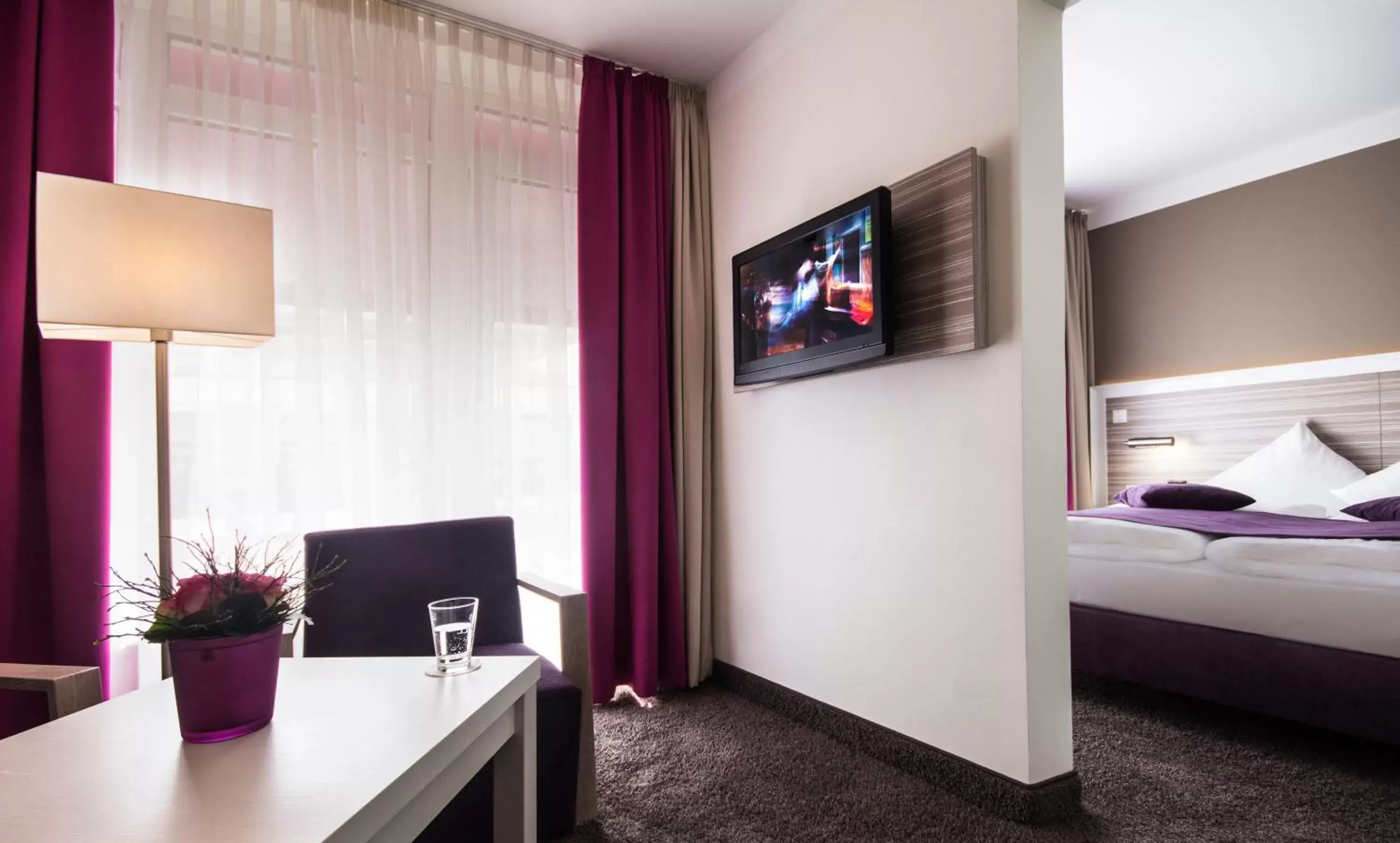 Bed, TV/Entertainment Center in Hotel Mirabell by Maier Privathotels