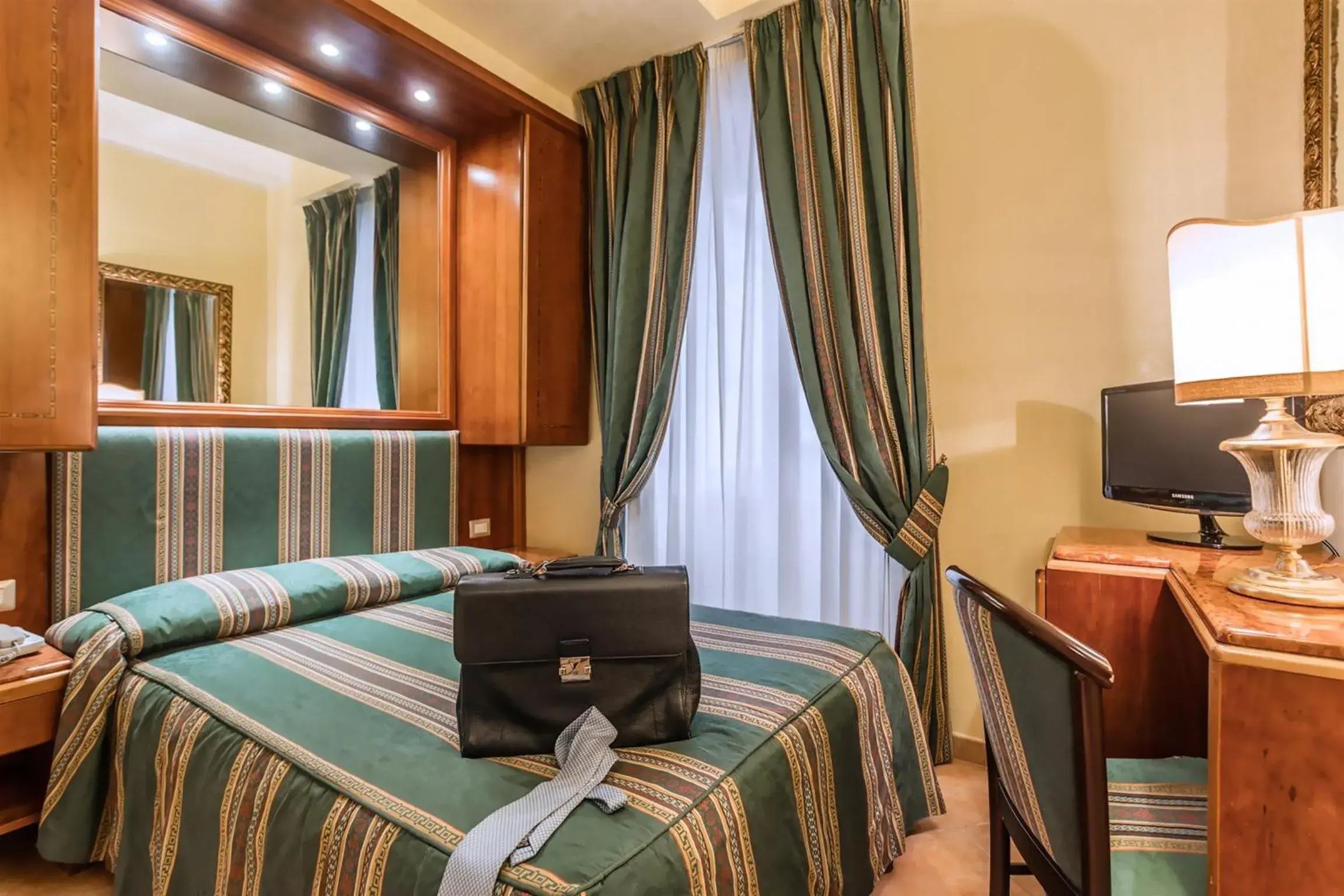 Bedroom, TV/Entertainment Center in Raeli Hotel Regio