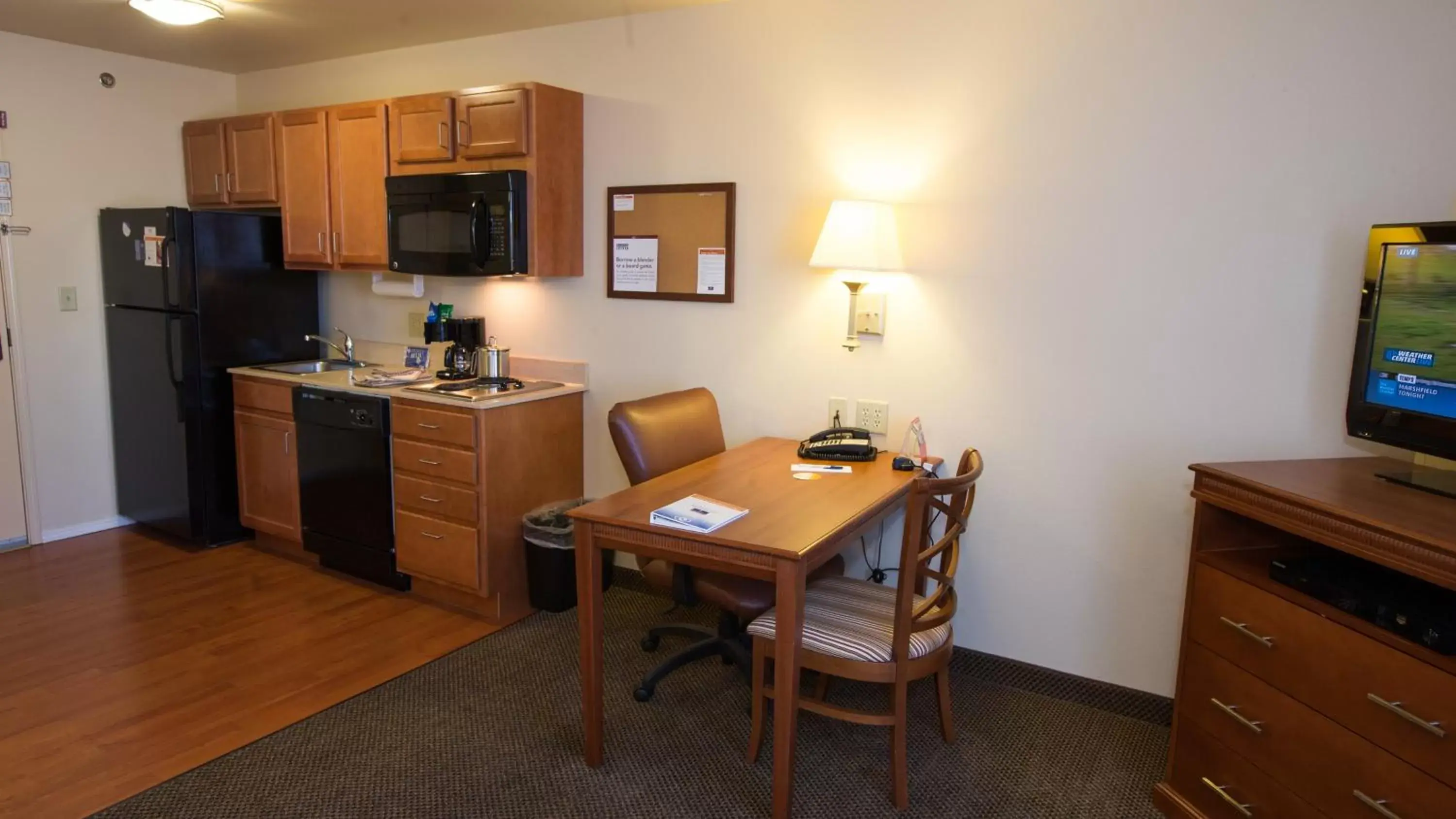 Bedroom, Kitchen/Kitchenette in Candlewood Suites Joplin, an IHG Hotel