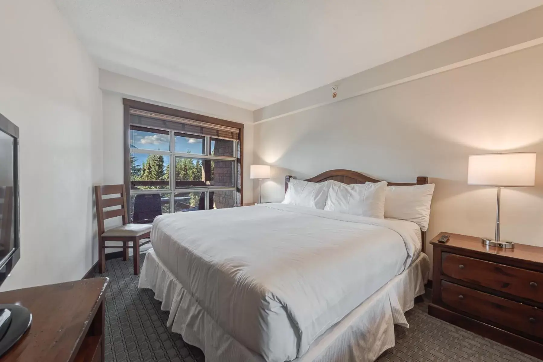 Bed in Blackcomb Springs Suites by CLIQUE