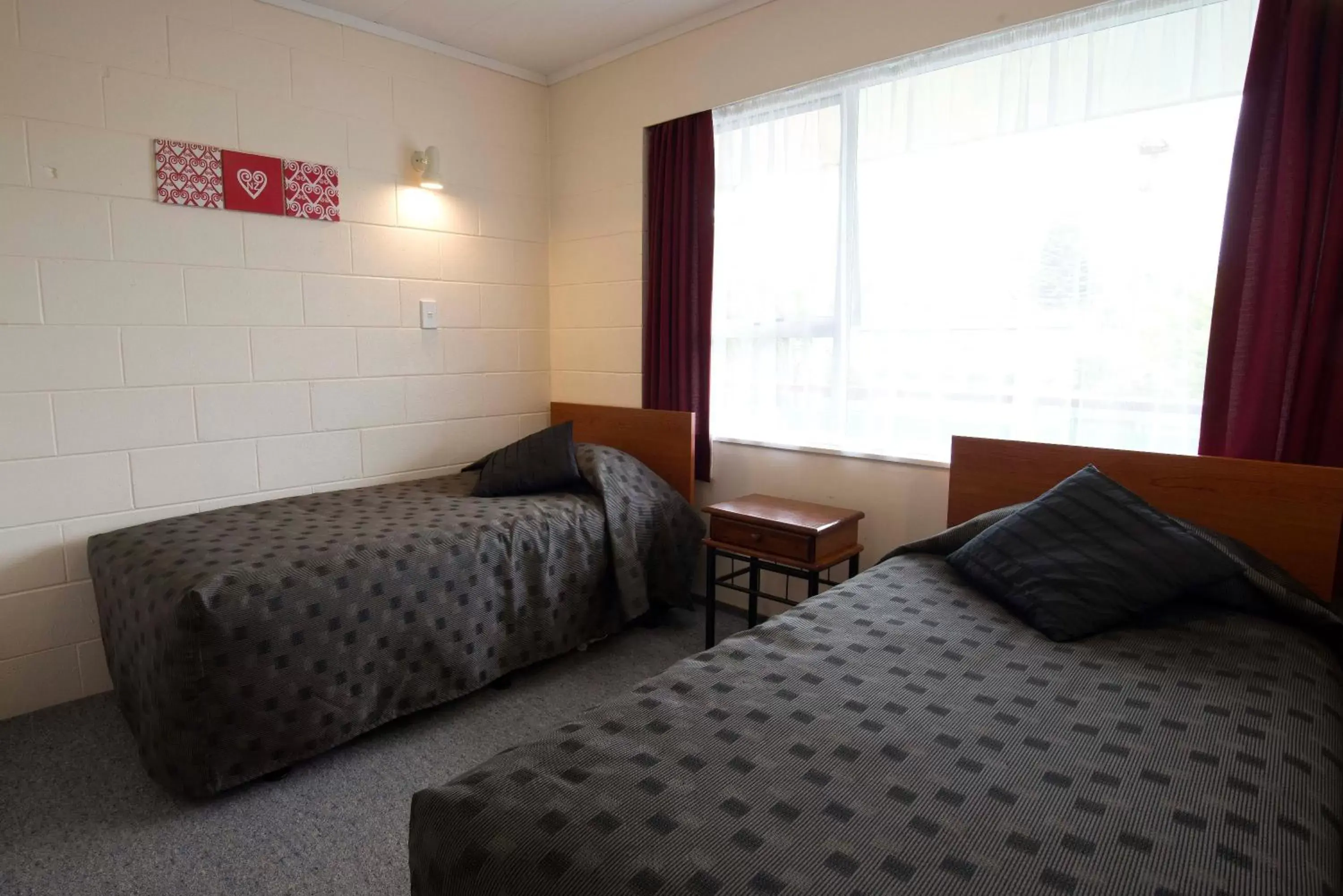 Bed in Kapiti Gateway Motel