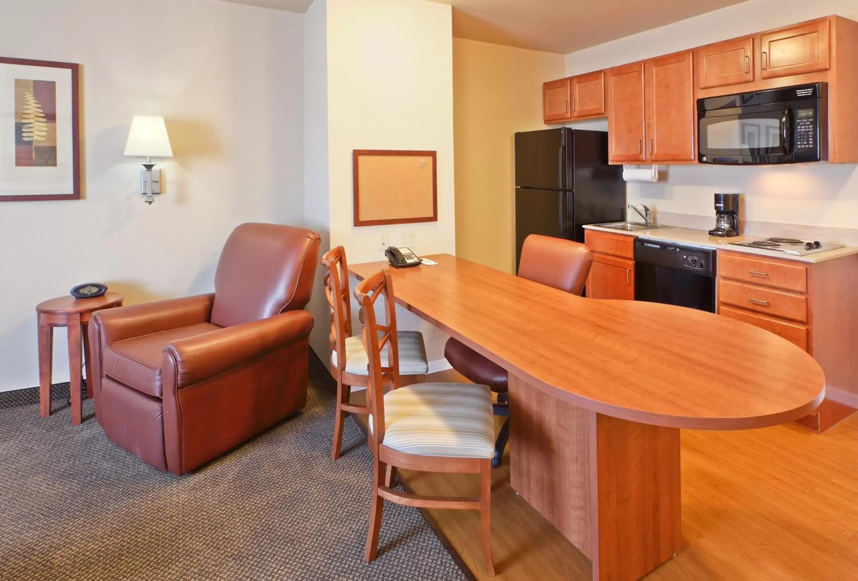 Bedroom, Kitchen/Kitchenette in Candlewood Suites Fayetteville, an IHG Hotel