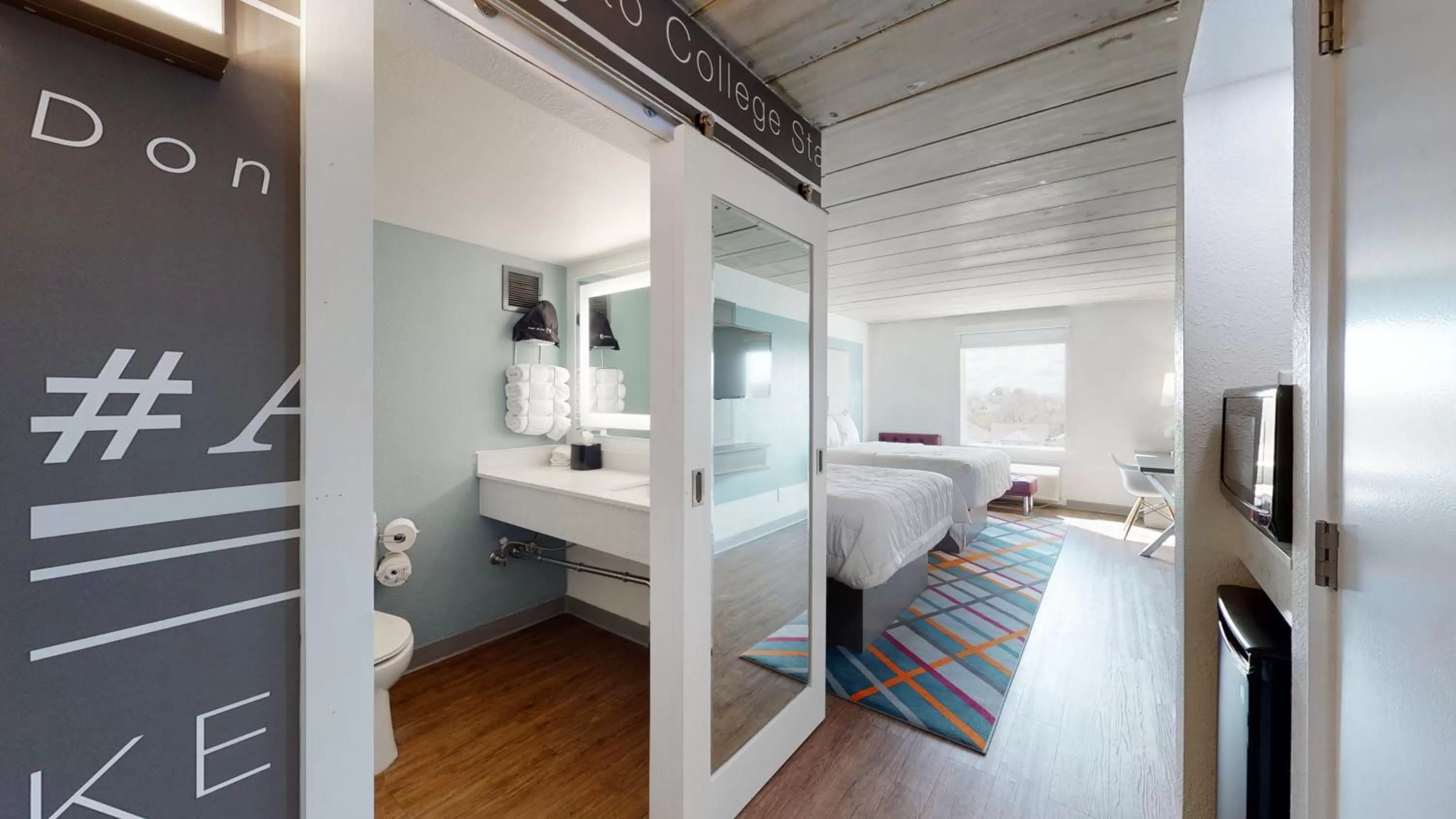 Bathroom, Bed in voco College Station Aggieland by IHG