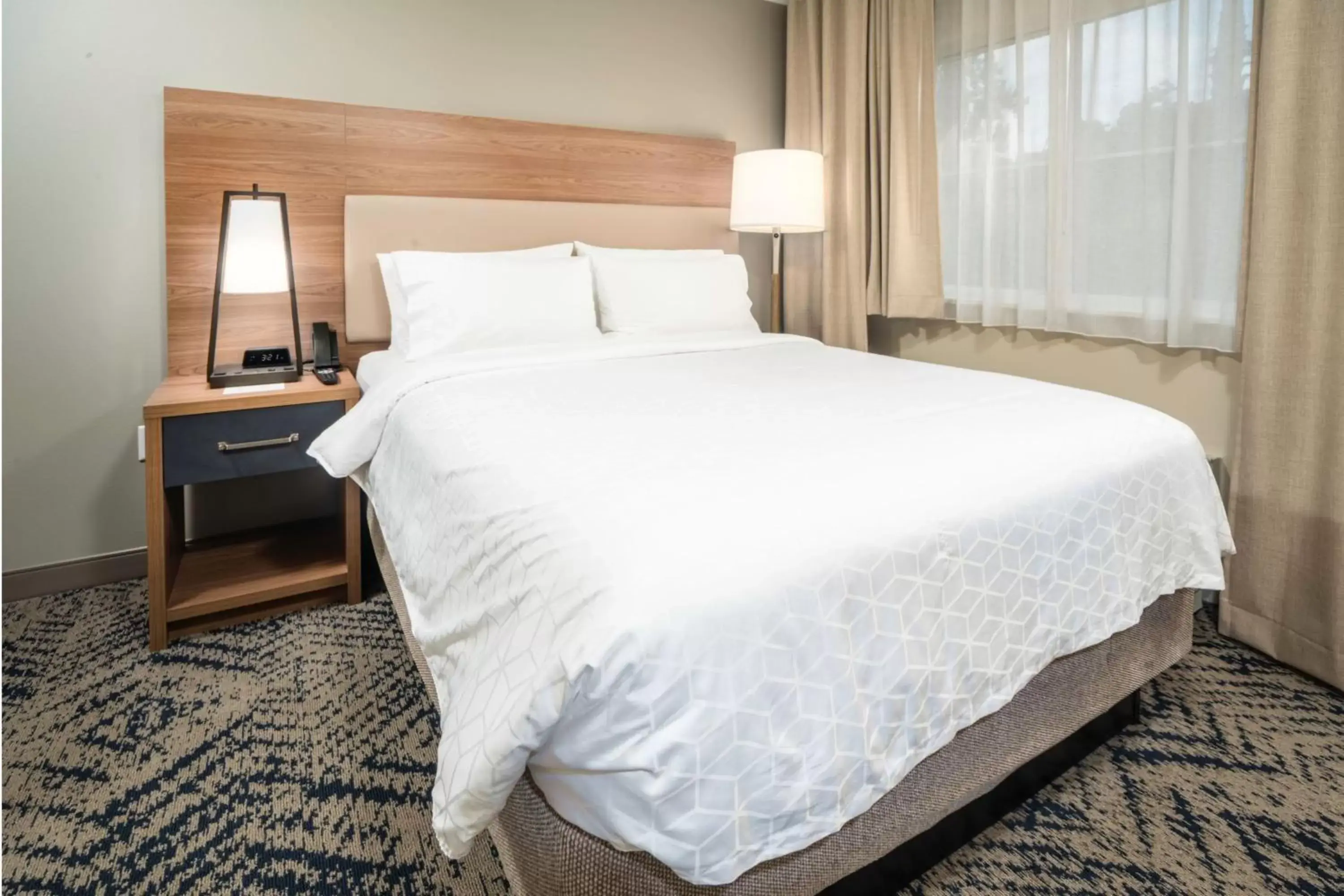 Bed in Candlewood Suites Charleston – Mt. Pleasant, an IHG Hotel