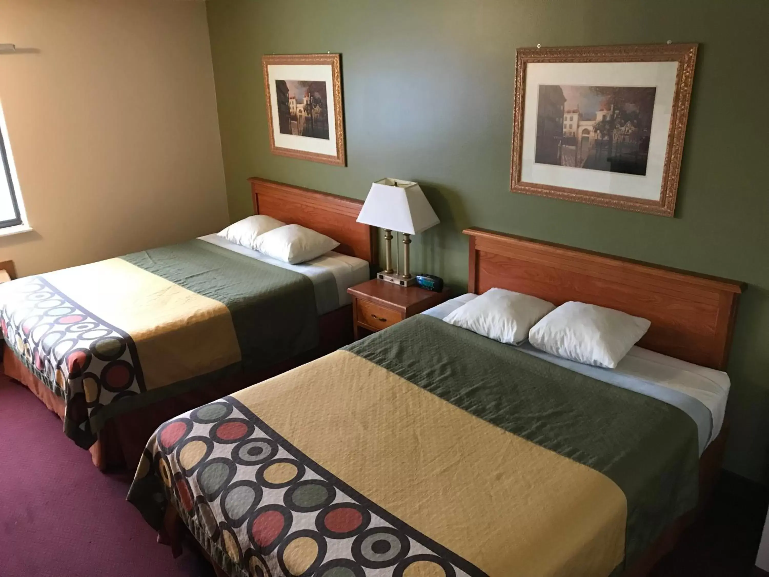 Bed in Heartland Hotel & Suites