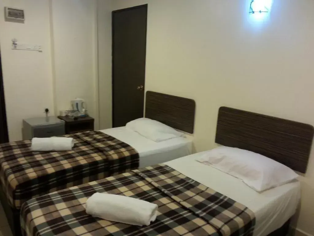 Bed in ISLAND TIME MOTEL KUAH