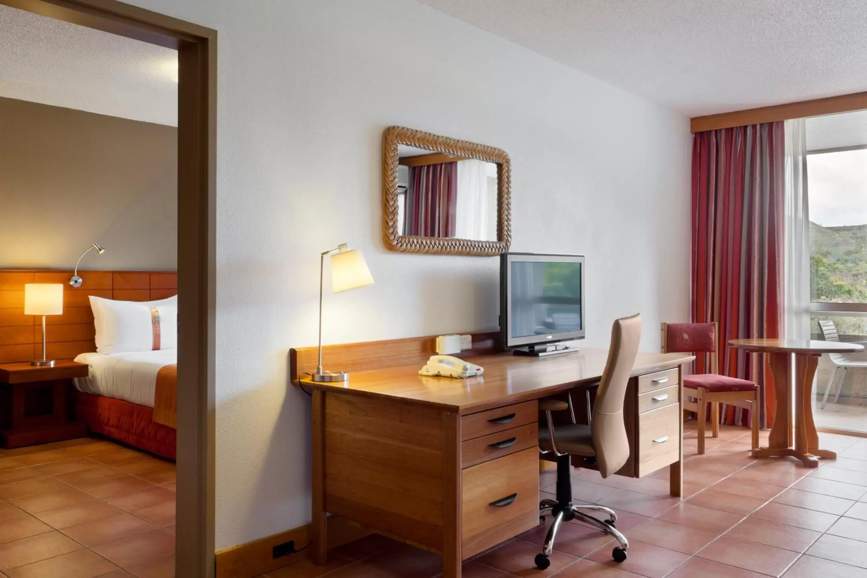 Seating area, TV/Entertainment Center in Holiday Inn & Suites Port Moresby, an IHG Hotel