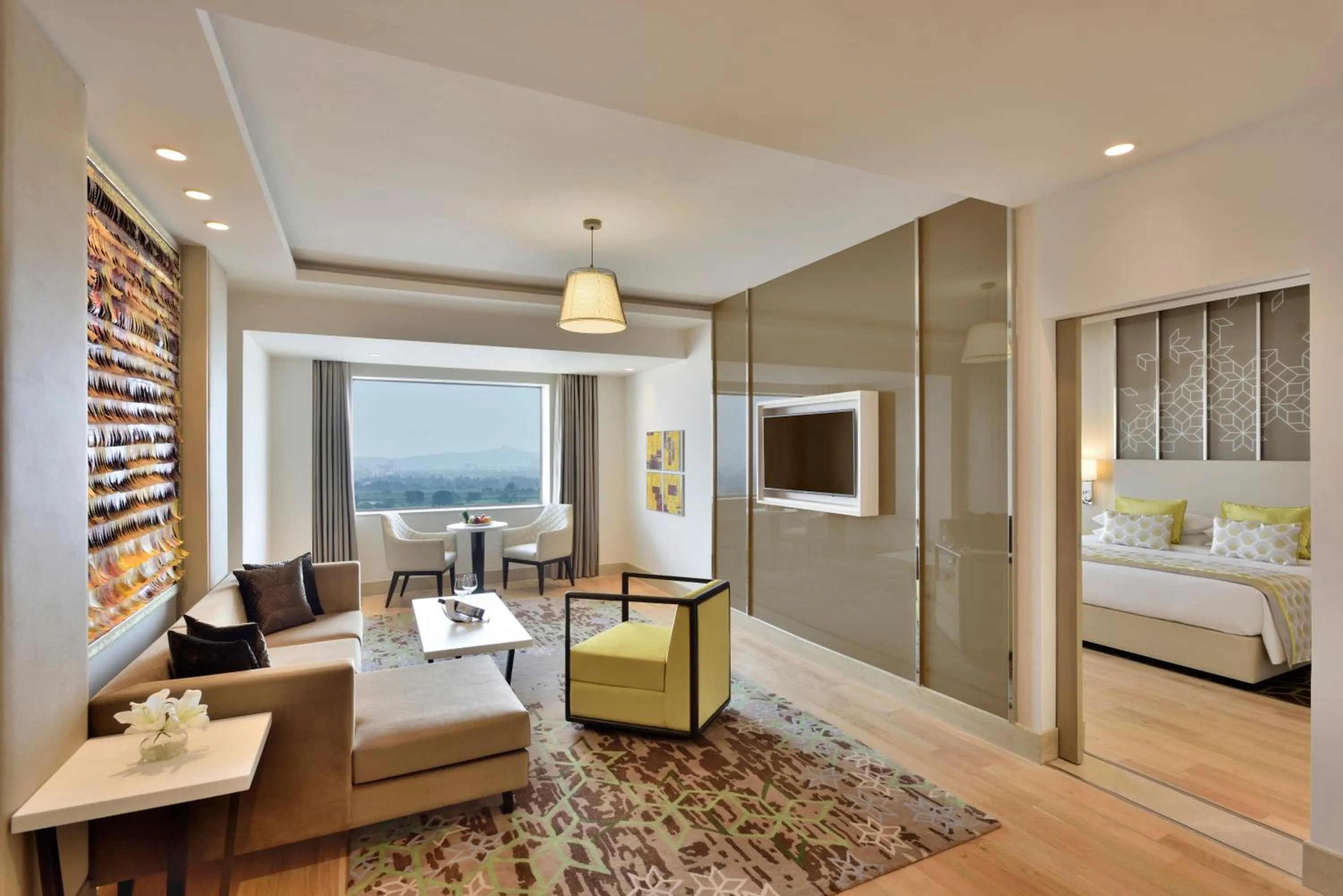 Living room, Bed in Radisson Gurugram Udyog Vihar