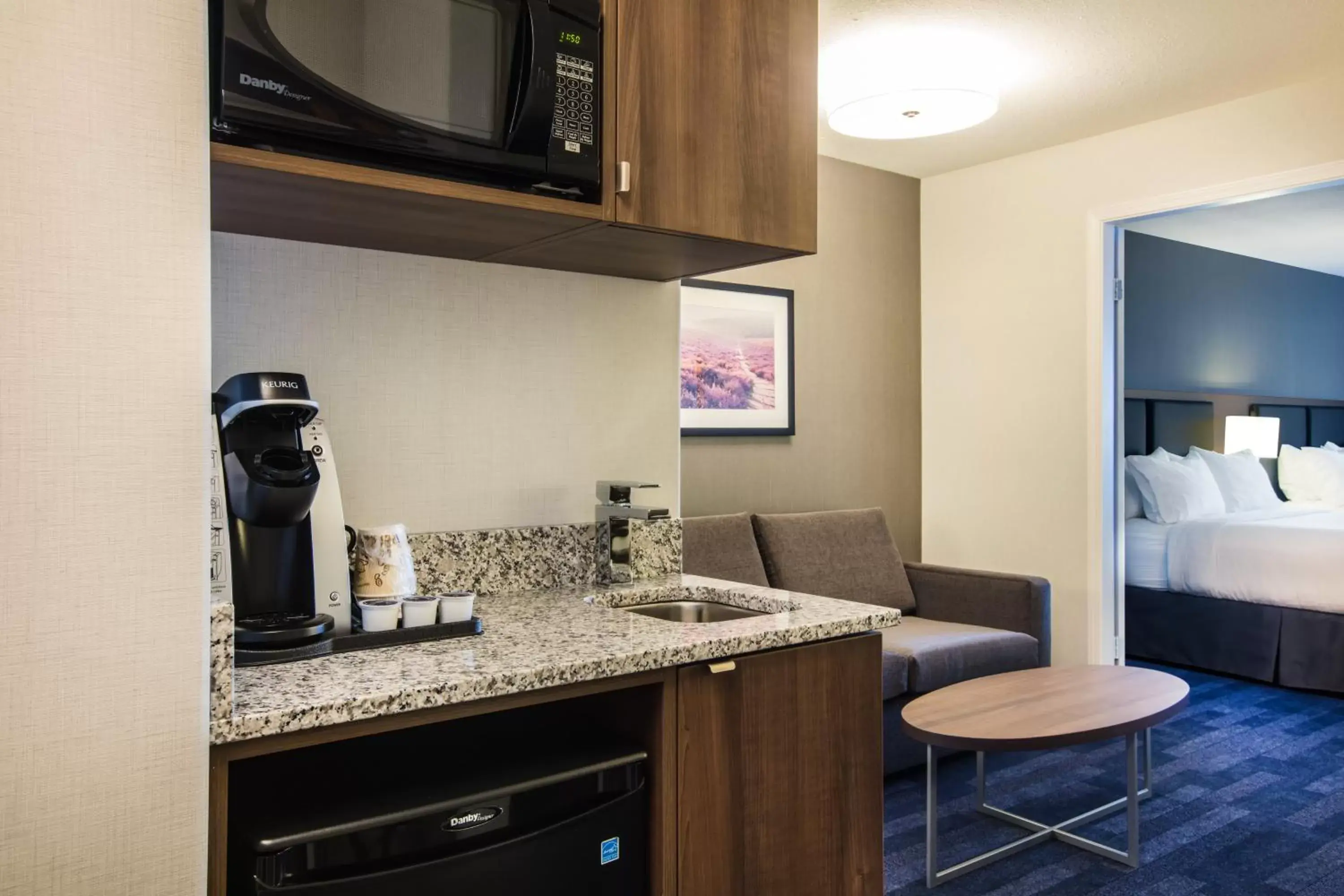 Bedroom, Kitchen/Kitchenette in Holiday Inn & Suites Grande Prairie, an IHG Hotel