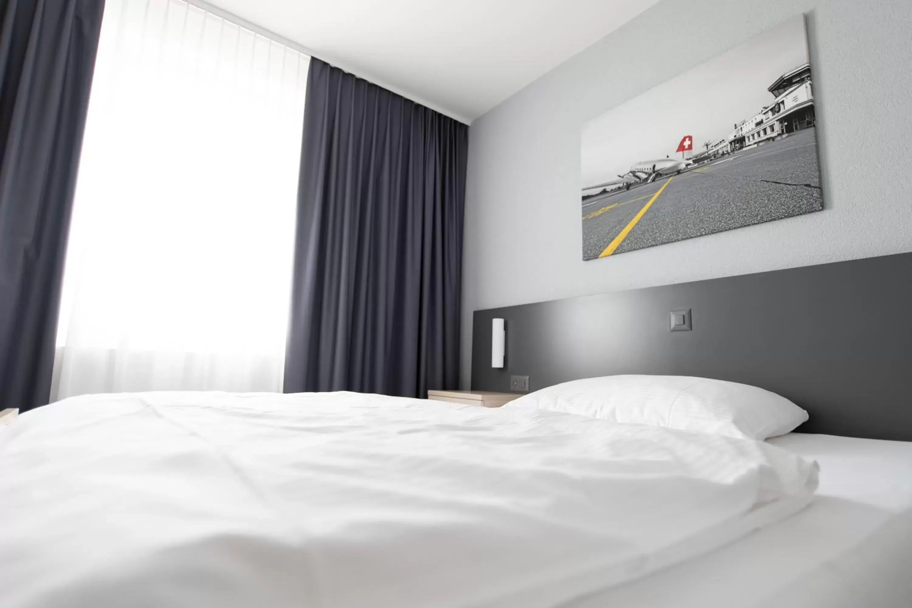 Photo of the whole room, Bed in Airporthotel Grenchen