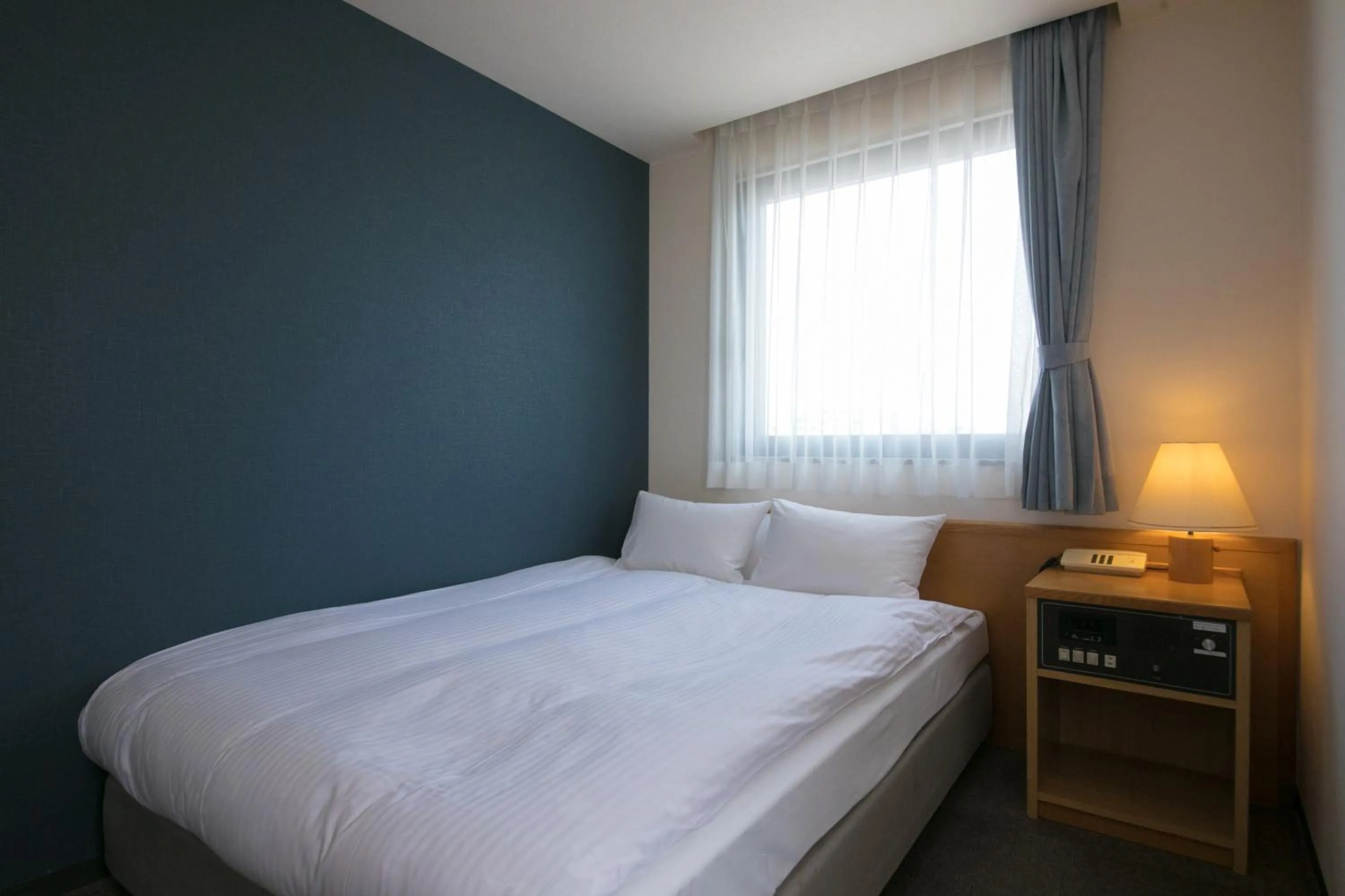 Bed in Heiwadai Hotel 5