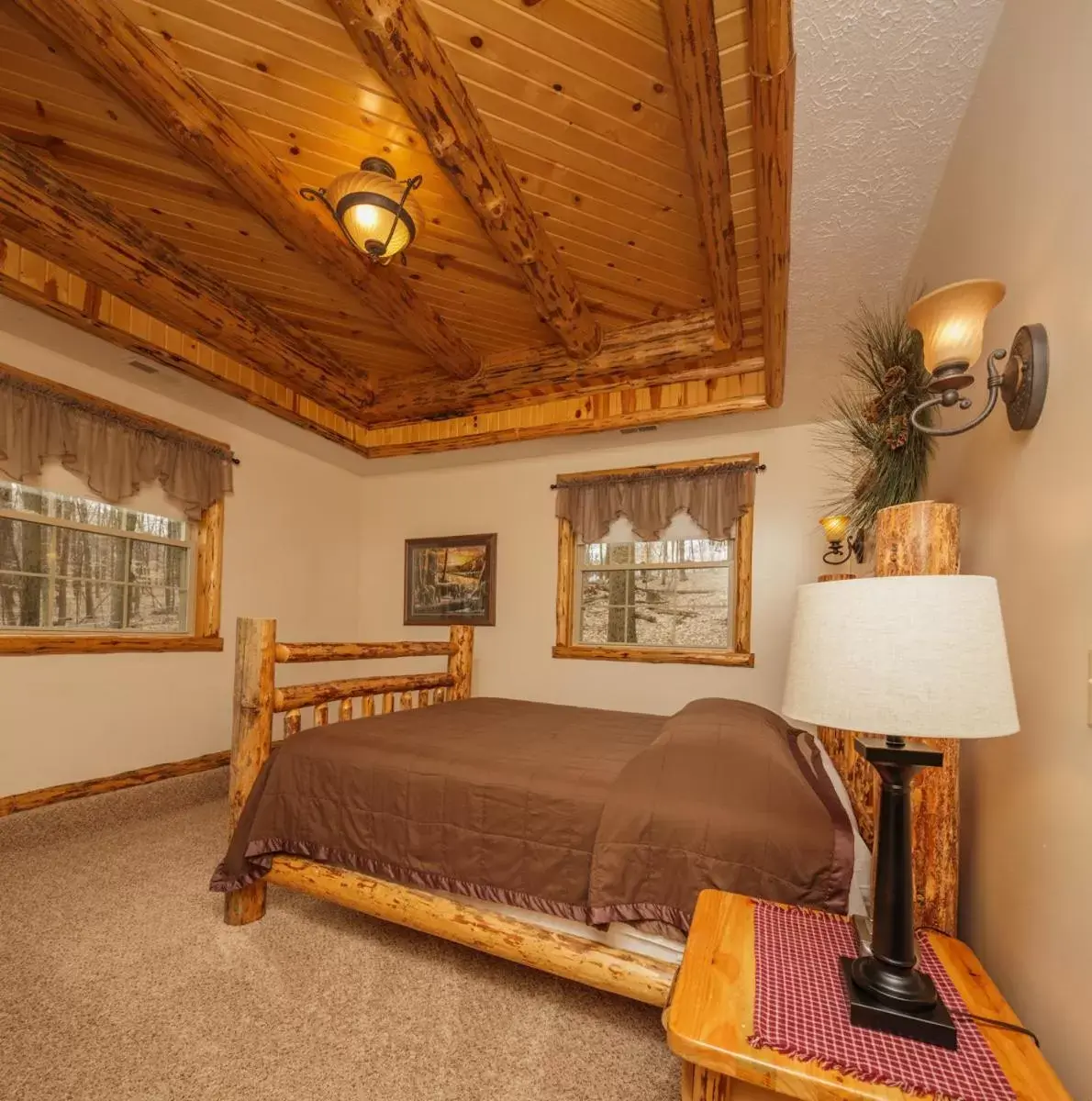 Bed in Sojourner's Lodge & Log Cabin Suites