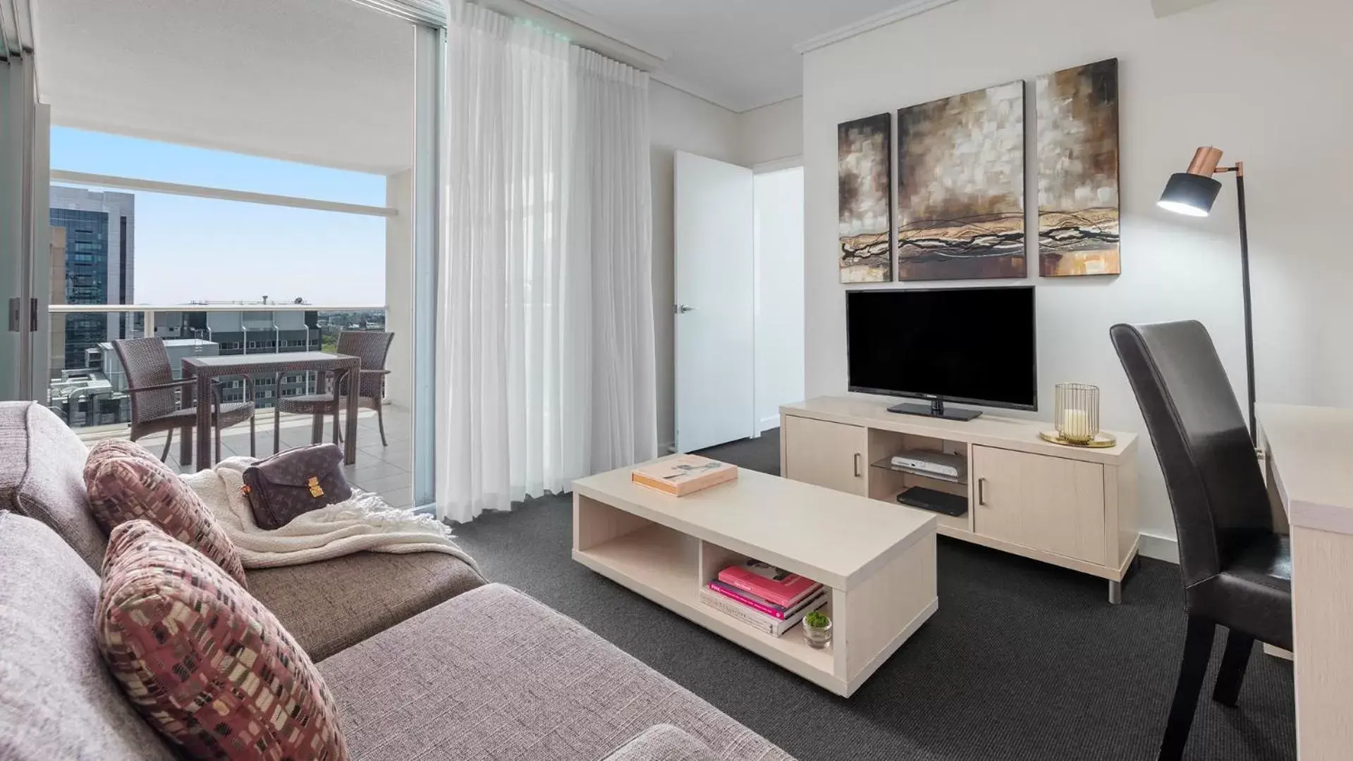 TV and multimedia, Seating Area in Oaks Brisbane Casino Tower Suites