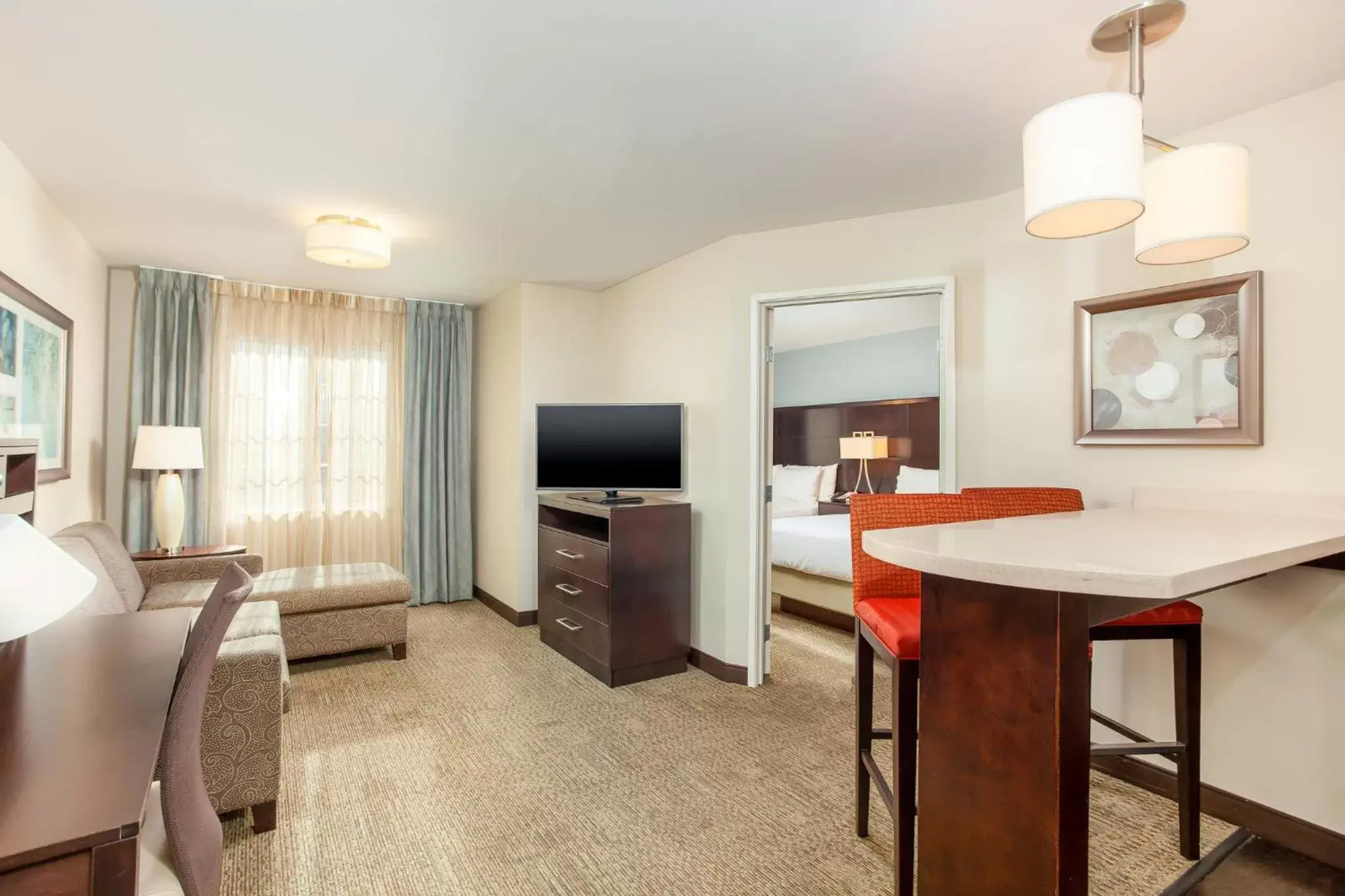 Bedroom, TV/Entertainment Center in Staybridge Suites Chandler, an IHG Hotel