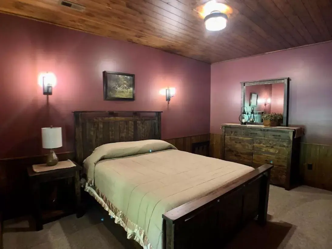 Bed in Sojourner's Lodge & Log Cabin Suites