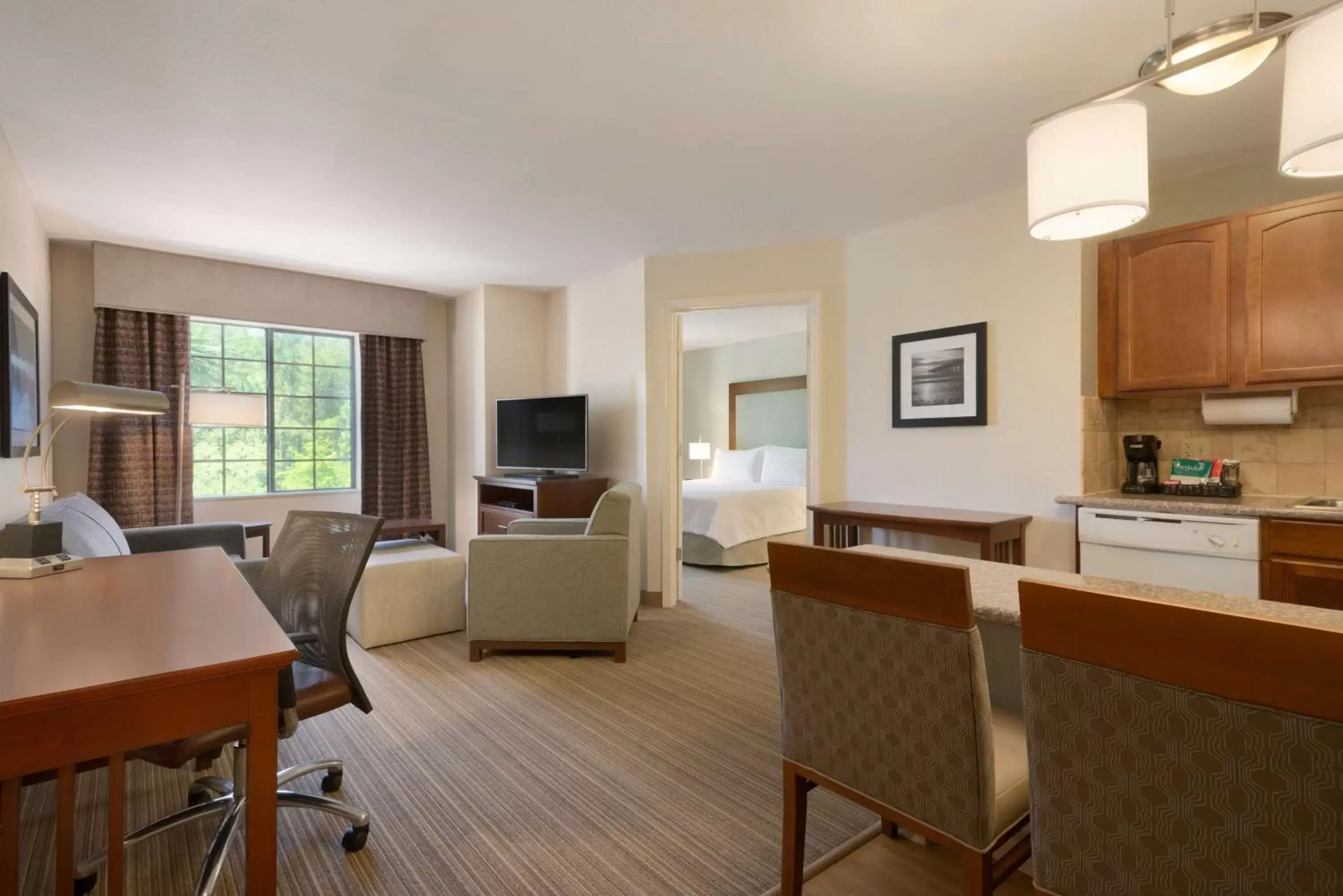 Bed, Dining Area in Homewood Suites Jacksonville Deerwood Park