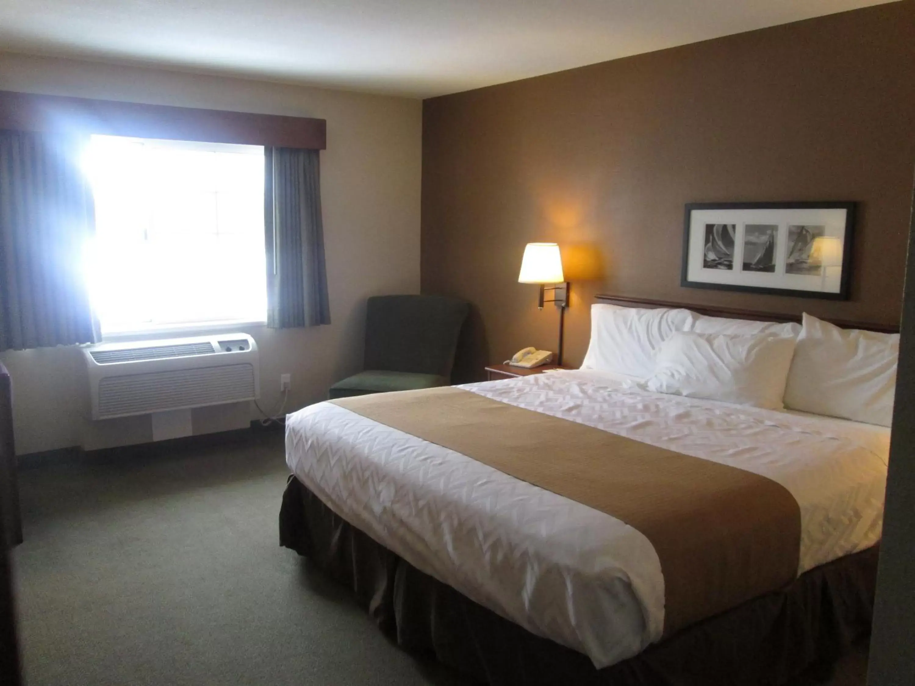 Bed in AmericInn by Wyndham Charlevoix