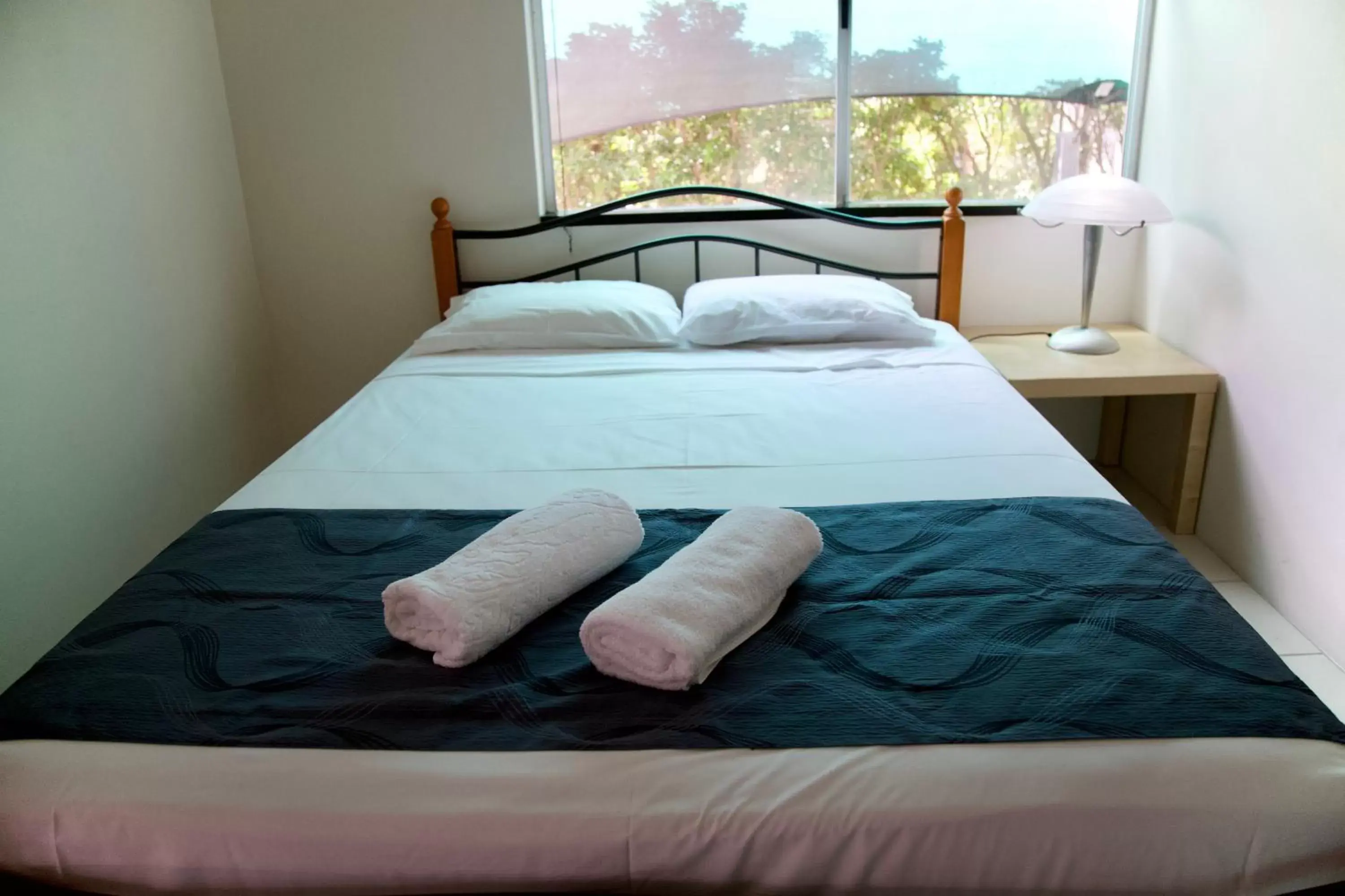 Bed in Reef Gateway Apartments