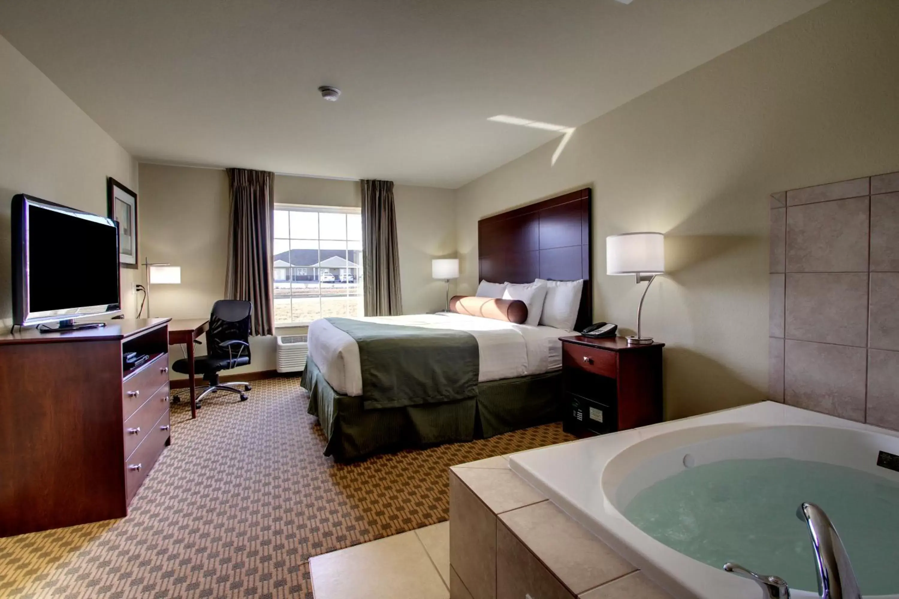 Bedroom, Bed in Cobblestone Inn & Suites - Rugby Bedroom, Bed in Cobblestone Inn & Suites - Rugby